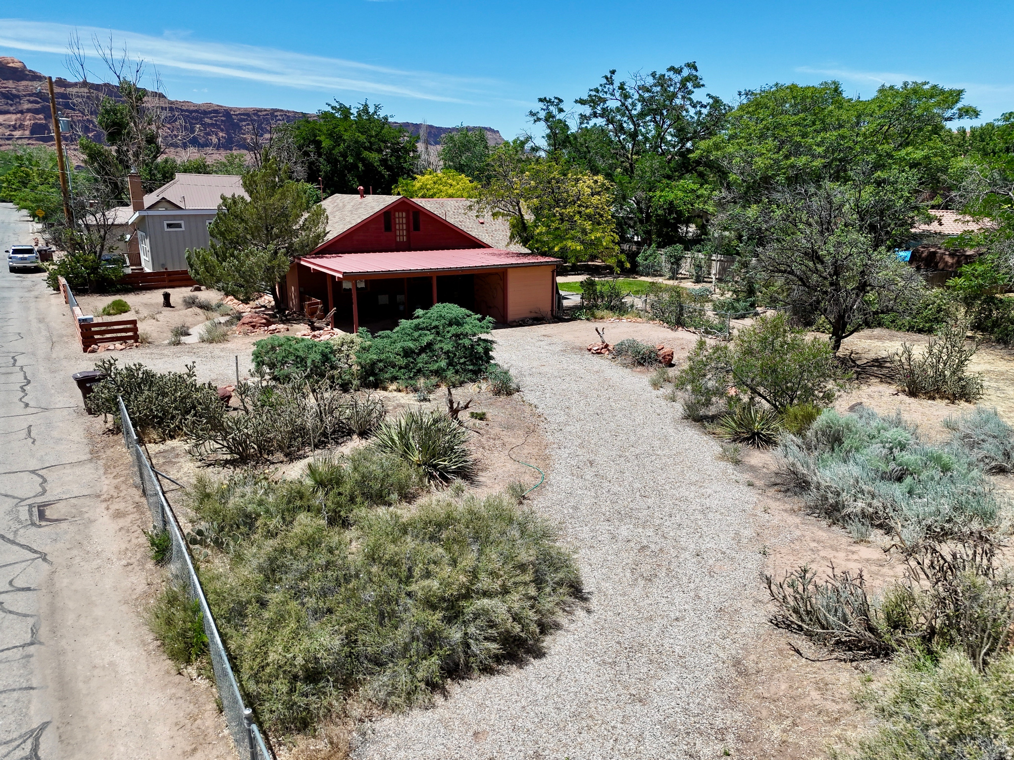 Opportunity awaits in the heart of downtown Moab. Situated on a generous .43-acre lot, this property offers a rare combination of space, location, and potential. Surrounded by mature trees and framed by Moab's iconic red rock scenery, the home retains its vintage character and provides a blank canvas for renovation, restoration, or reimagining.  The expansive lot offers room for gardens, outdoor living spaces, workshops, additional parking, or future improvements (subject to city approval). An enclosed dog run is already in place, making the property especially appealing for pet owners. The property also includes 1.5 acre-feet of irrigation water supplied by the well, a valuable asset for maintaining landscaping, gardening, or other outdoor uses.  Conveniently located within walking distance of downtown Moab's shops, restaurants, parks, and community amenities, this property presents a unique opportunity for homeowners, investors, or anyone seeking an in-town property with room to grow. Sold in its current condition, this is a chance to unlock the potential of one of Moab's increasingly rare large-lot properties.