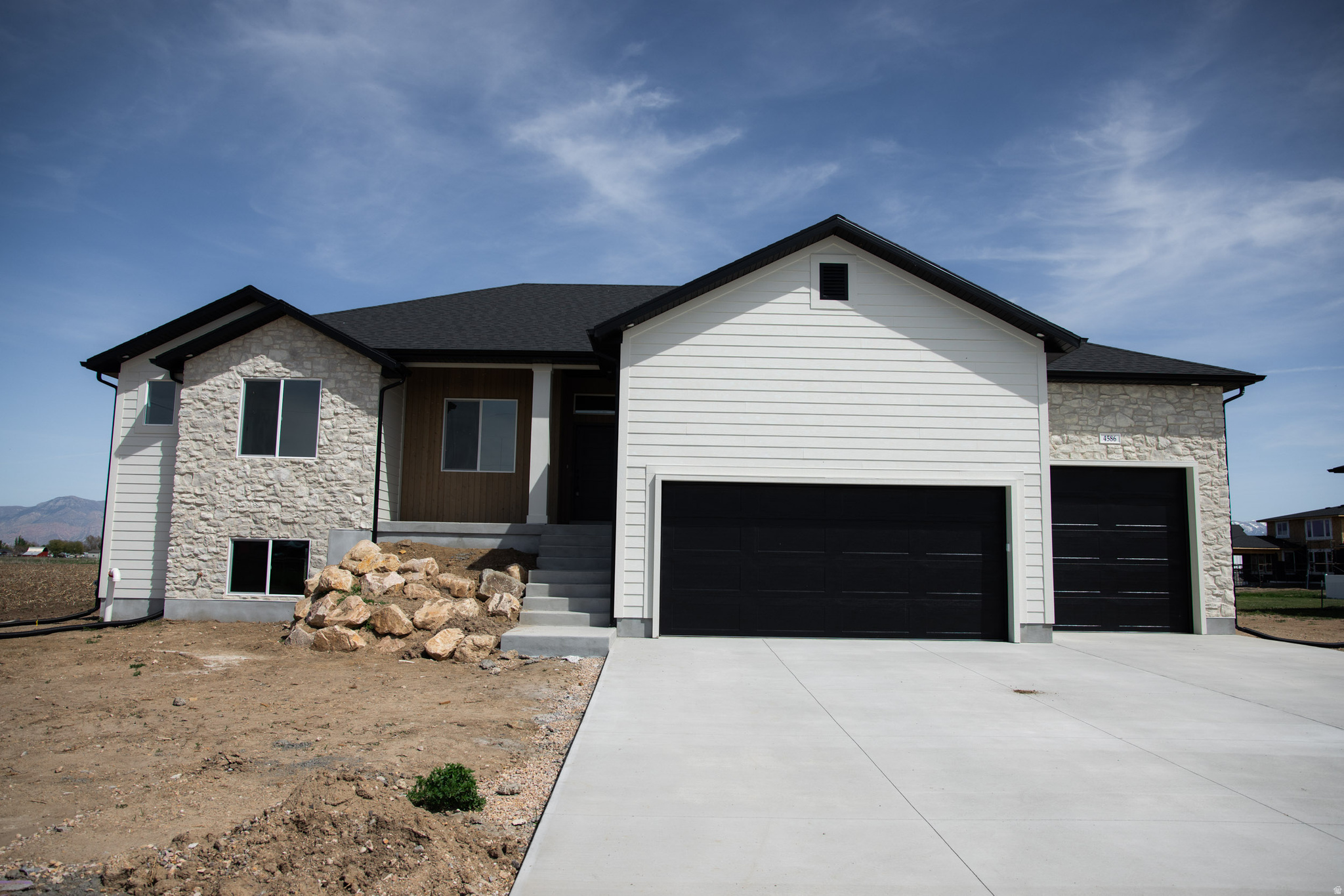 Builder Incentive: $10,000 towards buyers closing costs or Rate buy down!  Brand-new luxury home in Hooper on .55 acre lot! This beautifully designed home features high-end construction and premium finishes throughout. The open floor plan includes LVP flooring, two-tone paint, accent walls, and a stunning 5-foot linear fireplace. The gourmet kitchen offers custom beige cabinets with soft-close doors and drawers, Level 6 quartz countertops, a large island with pendant lighting, custom backsplash, and upgraded Bosch appliances with a gas cooktop and hood. The primary suite includes a spa-like bathroom with euro glass shower, floor-to-ceiling custom tile, and a soaker or jetted tub. Enjoy outdoor living with a covered deck and walkout basement patio. Additional features include a mudroom with lockers, upgraded lighting and fixtures, insulated 3-car garage with oversized doors, blown-in insulation, 95+ furnace, and tankless water heater with recirculation for instant hot water. Exterior finishes include custom stone, Hardi board, cedar, and stucco. A rare opportunity to own a high-quality new construction home with space, style, and modern upgrades in a great Hooper location! Home estimated to be completed Around April 10th.
