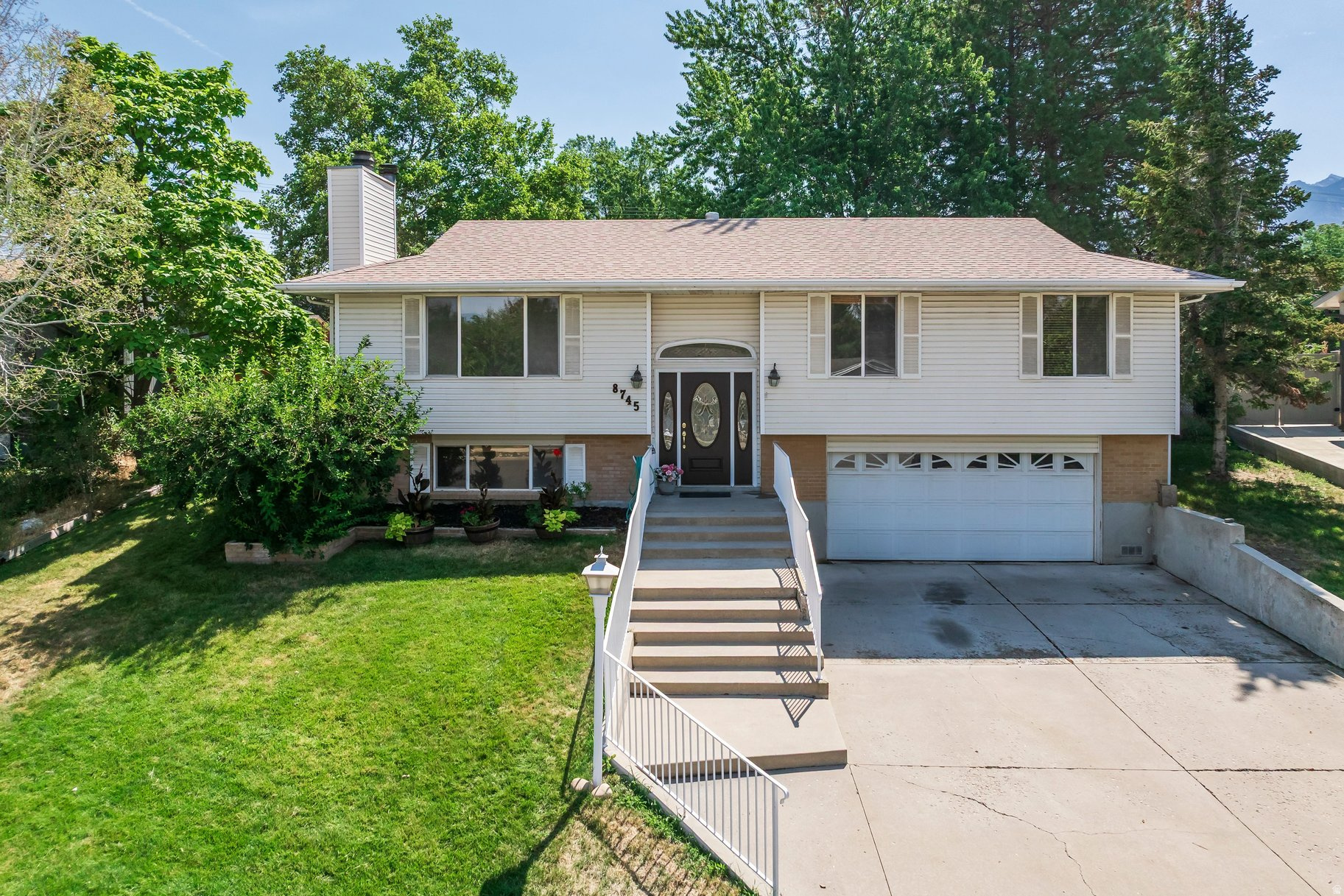 One-of-a-kind split-entry home in a highly sought-after neighborhood! This spacious 4-bedroom, 4-bathroom home features an extraordinary addition that expands the kitchen and creates a stunning oversized great room-perfect for entertaining, gathering with family and friends, or simply enjoying extra space to spread out.  Major updates have already been completed, including a new roof, new furnace and A/C, new water heater, and new windows, giving you peace of mind for years to come. All that's left to do is move in and make it your own.  Step outside to a beautifully landscaped backyard filled with cover patio, mature trees, vibrant plants, rose bushes, and a garden area. As the finishing touch, you'll enjoy breathtaking views of the Wasatch Mountains, creating the perfect backdrop for relaxing or entertaining outdoors.
