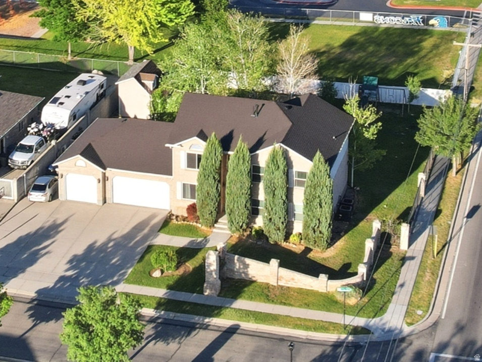 *$30,000 PRICE IMPROVEMENT*  Spacious & inviting, this South Jordan home features 9 bedrooms and 4 bathrooms, ensuring there will always be room for family & friends. Enjoy peace of mind knowing many big-ticket items have been replaced, including the roof (2024), TWO furnaces & AC units (2022), most west-facing windows (2022), & kitchen appliances (within last 5 years). Main floor living & kitchen flow seamlessly, making entertaining easy. Just off the kitchen is a functional mudroom with access to the backyard & garage, plus a craft room with built-in desk/cabinets. 2nd family room in the basement for movies & game nights, plus abundant storage. Escape upstairs to the large primary suite with vaulted ceilings, walk-in closet, and separate tub/shower. Relax in the huge back yard, where kids will love the swing set & charming shed/playhouse, while grownups will appreciate the big 3-car garage with extended third bay & NEMA 14-50 240V outlet. Plus plenty of driveway parking for cars/RVs. All appliances, including refrigerator, washer/dryer, & basement freezer are included. Location is ideal, with an elementary school behind the property, quick access to Bangerter Highway, & shopping like Costco & Walmart just 5 minutes away! Square footage estimates provided as a courtesy only, buyer/buyer's agent to verify all listing info.