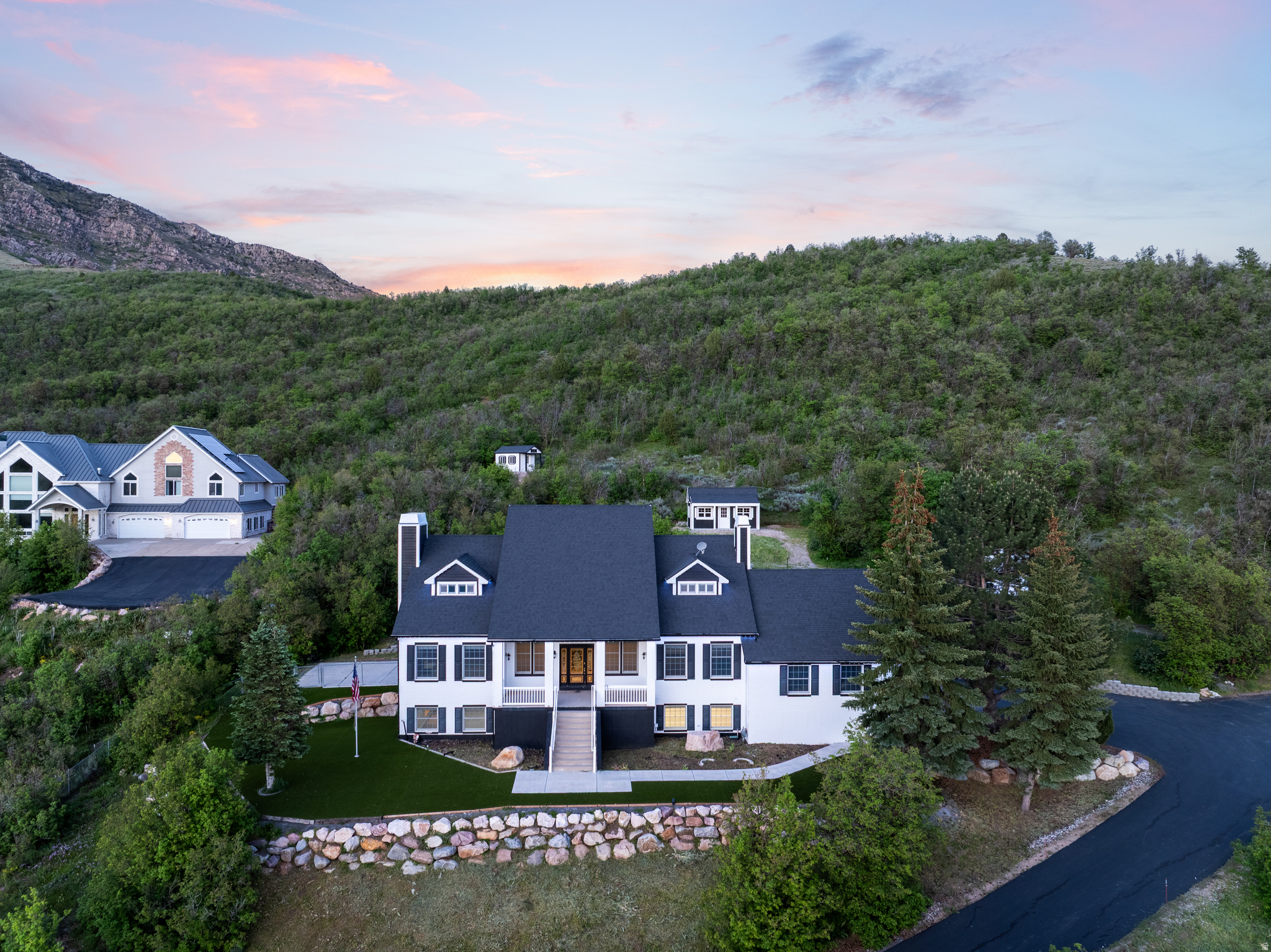 Tucked away on 2 private acres just minutes from Snowbasin Resort and Pineview Reservoir, this stunning Ogden Valley retreat offers panoramic views, unmatched privacy, and direct access to nature. Bordering nearly 1,000 acres of protected conservation land, the property provides endless hiking, wildlife, and unforgettable sunsets right from your backyard. This beautifully updated 5,000+ sq. ft. home was designed for both comfort and entertaining, featuring a gourmet kitchen, spacious home office, and luxurious primary suite with a steam shower, jetted tub, fireplace, and oversized walk-in closet. After skiing at Snowbasin Resort or Powder Mountain, relax in the back deck while taking in sweeping valley views. The property also includes a massive shop/outbuilding with room for all your toys, backup generator, custom greenhouse, enclosed gazebo, fire pit area, expansive patio, fruit trees, and extensive landscaping. A rare opportunity to own a private mountain-view estate in the heart of Ogden Valley.