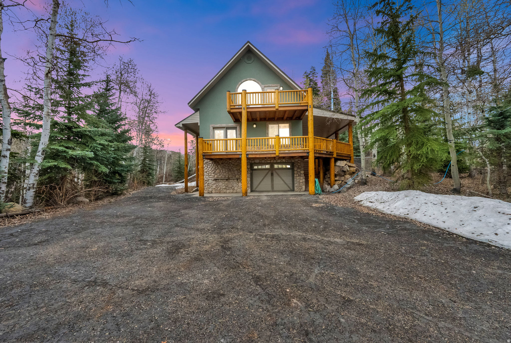 Tucked away among towering aspens and pines in the highly sought-after Timber Lakes community, this extraordinary mountain retreat offers the ultimate blend of privacy, comfort, and year-round adventure. Sold fully furnished and completely turn-key, this cabin is ready for immediate enjoyment. Designed for gathering and making memories, the spacious great room welcomes you with an open, inviting layout ideal for hosting family and friends. Expansive windows bring the outdoors in, while multiple outdoor living spaces elevate the experience. These include a large main-level deck perfect for entertaining and a private deck off the primary suite, you can enjoy your own quiet sanctuary to take in the fresh mountain air. Set on a beautifully secluded acre and a half lot, the property offers exceptional privacy with a paved, flat asphalt driveway and ample parking for guests, trailers, and all your recreational toys. Every detail has been thoughtfully considered for both comfort and functionality, featuring two attached heated garages, a dedicated workshop, and abundant storage throughout.This property is fully equipped for true mountain living with a buried 1,000-gallon propane tank and an additional 300-gallon gas storage tank. Experience peaceful summer evenings under the trees and cozy winter nights in the winter, this cabin truly has it all. Only an hour to the SLC airport, 45 minutes to Provo and just minutes from all the fabulous amenities of the Heber Valley, Midway & Park City.  Now is your opportunity to own a move-in-ready mountain escape where seclusion, adventure, and relaxation all come together!