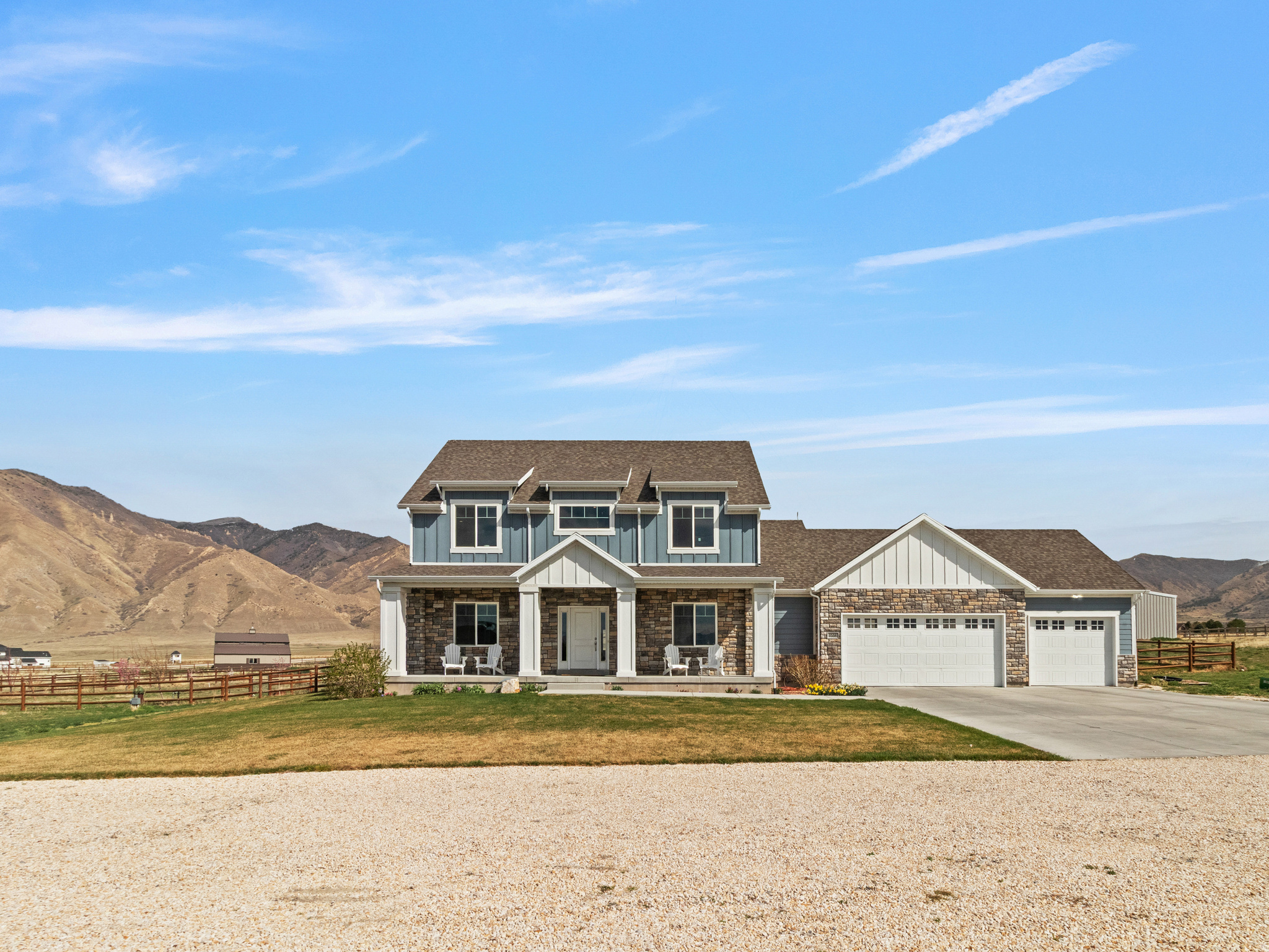 Country charm with amazing mountain views.  This beautiful well maintained home offers open spaces and plenty of room to grow.  On the inside you will find a large farm style kitchen with plenty of cabinet space and an extra large walk in pantry. There is room for the family to be entertained on the main level or go downstairs to a climbing wall and movie/game room.  The primary bedroom has mountain views that anyone would love to wake up to. This well built custom home has additional insulation throughout including sound proofing insulation between the three living levels. On the outside you will enjoy a fenced orchard with growing fruit trees, a fully fenced backyard, hammock poles, large playground, and in-ground trampoline.  And don't forget the 40' x 60' shop that can be tailored to meet your dreams. Water is provided via a shared well and owned water rights 15-5601 (2 acre feet) and 15-5620 (.5 acre feet). Water heater replaced March 2026. Square footage figures are provided as a courtesy estimate only and were obtained from building plans .  Buyer is advised to obtain an independent measurement.