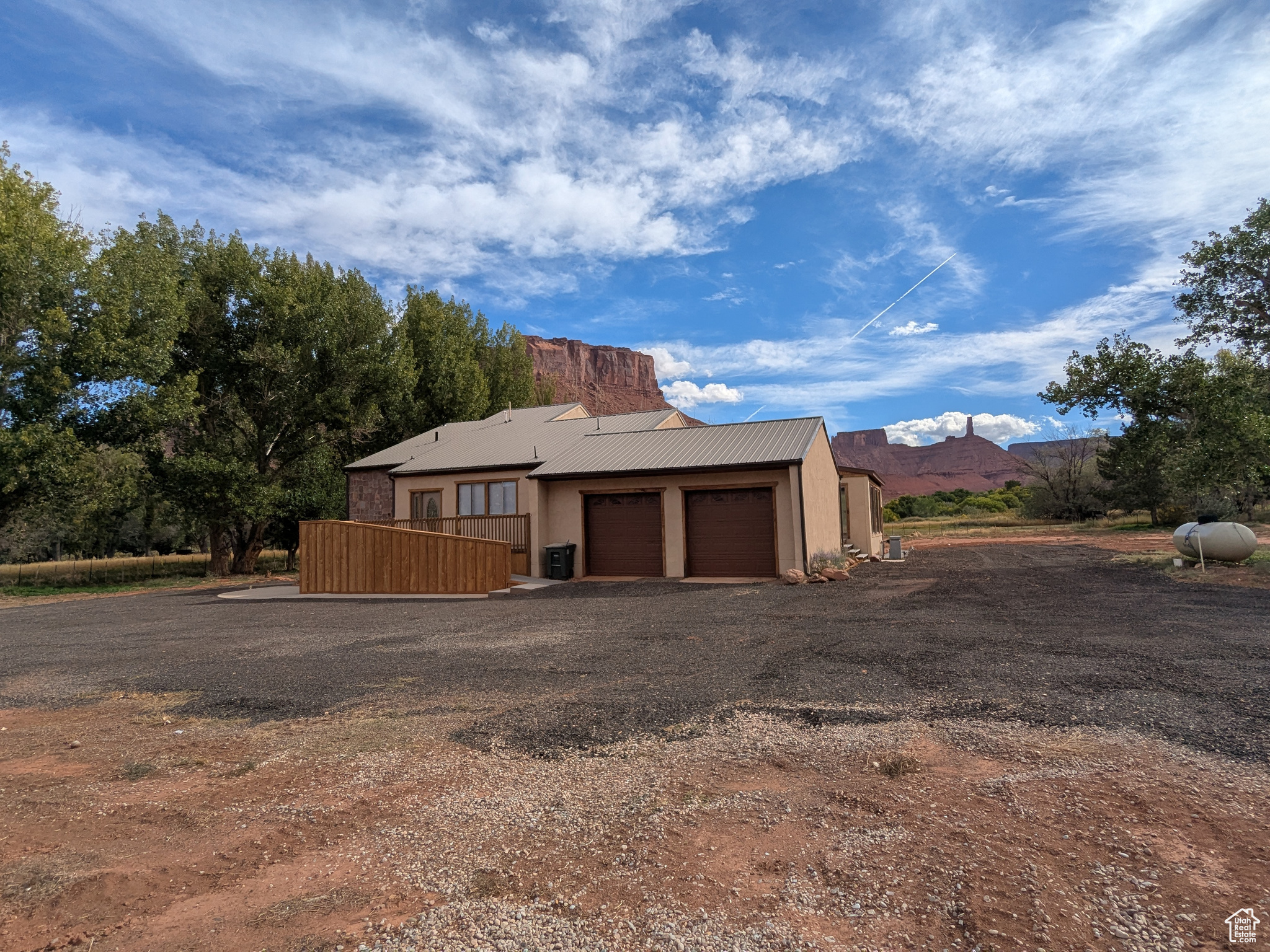 Large home with 5 bedrooms (3 levels) and 3 bathrooms and 2 car attached garage; in lovely and quiet Castle Valley in close proximity to great recreational opportunities, such as rock climbing world famous Castleton Tower, river running on the Colorado River, 4 wheeling nearby, hunting and fishing in the LaSal Mountains, and lots of hiking and walking.  This home can accommodate multi-generational living with it's  5 bedrooms and 3 baths on 3 levels., The lower level basement has two bedrooms, bath and a large den/office, which would be ideal for a theater room or gym.. Very large irrigated and fenced pasture for horses and livestock with 4 shares of surface irrigation water. Also, the water well has a valid Town of Castle Valley Water Use Agreement and Permit for 16.77 acre feet , which is enough for one family and 2.72 acres irrigated, which will transfer automatically with the property. Great horse property with pasture. Brand new electric with ducted HVAC system for central air and heat throughout. Mature shade trees. Large decks with incredible views of Castleton Tower, Priest and Nuns, and Parriott Mesa. Detached exercise pool house ("As Is")  with deck on 2 sides. Very large detached shop building for storage of your toys and tools and work space. Close to Castle Valley Inn for your visitor's lodging.  Rare opportunity.
