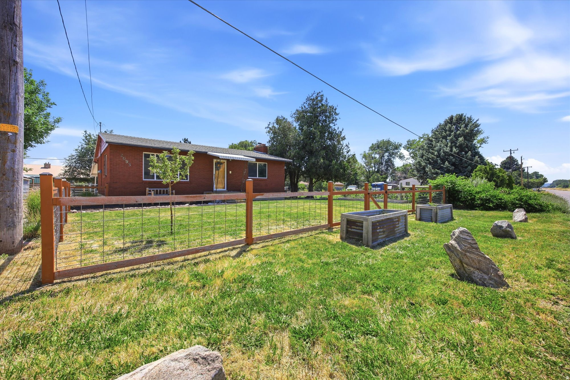 Open House: Sat. July 11th from 11:00AM to 1:00 PM.  Welcome to your Uintah haven where usable land, fresh upgrades, and peaceful living come together. This charming property sits on a spacious lot with a fully fenced corral, established grow boxes, and a yard designed for anyone who loves space, animals, gardening, or simply room to breathe. A valuable half water share keeps the grounds green and productive, giving you flexibility for irrigation, gardening, and livestock. The detached 2car garage is freshly updated with brandnew garage doors and ideal for vehicles, storage, or workshop use. Inside, comfort is already taken care of with a new A/C unit, ensuring cool summers and efficient climate control. Uintah's rare combination of land, quiet streets, and quick access to Ogden Canyon, recreation, and amenities makes this property a perfect fit for buyers seeking space without sacrificing convenience.   Square footage figures are provided as a courtesy estimate only and were obtained from county records.  Buyer is advised to obtain an independent measurement.