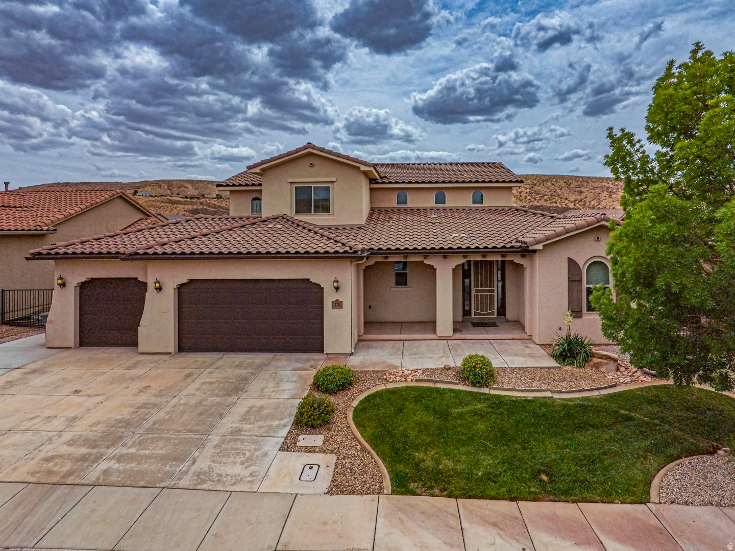 Spacious 4,312 sq. ft. three-level home in St. George offering 5 bedrooms plus an office, 3.5 baths, and a large 3-car garage. The open main living area features vaulted ceilings, updated kitchen countertops, a modern kitchen with large pantry, and newer Vinyl flooring and carpet. A standout feature is the fully separate lower-level casita/mother-in-law quarters with private exterior access, 2 bedrooms, full bath, kitchen, dining area, pantry, and its own laundry-ideal for multigenerational living, guests, or rental potential. Additional highlights include a wood-burning stove, soft water system, walk-in tub, large storage room, extensive garage shelving, covered front porch, fenced raised garden, mature fruit trees, utility shed, and a larger backyard. Enjoy access to two gated HOA pools and hot tubs, nearby walking paths, a city parks, schools, shopping, and convenient access to downtown St. George, St. George Regional Airport, and Zion National Park. Low HOA dues of $50/month.