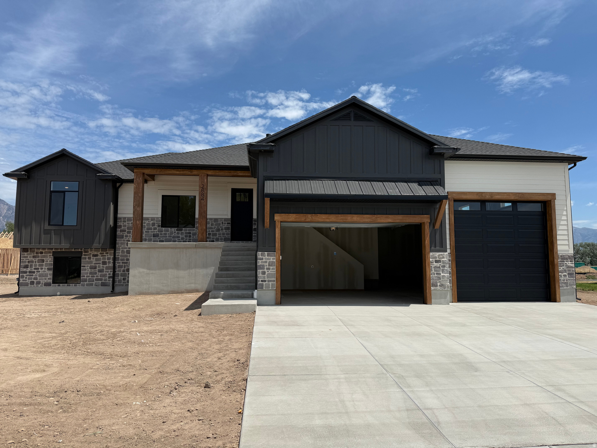 ***Open house Saturday 7/18 2:00-4:00. Dessert provided by Maison Miette!!***  (Professional photos coming Friday)   Welcome to this stunning new custom built home in the heart of Plain City, where luxury, functionality, and thoughtful design come together on nearly half an acre with breathtaking mountain views. This spacious home features an open concept floor plan with vaulted ceilings, abundant natural light through the large windows, and exceptional custom craftsmanship throughout. Every detail has been carefully considered, from the beautiful finish work and designer selected tile in the bathrooms, to the high end finishes that create a warm, elegant feel. One of the home's standout features is the basement ADU (mother-in-law apartment) with 9-foot ceilings! This offers incredible flexibility for multi-generational living, long-term rental income, or a private guest retreat. The basement also has a large, unfinished area that could be completed to add another bedroom and bathroom, office, gym, theater, or leave it as a large storage space.  Outdoor living is just as impressive with a large covered deck overlooking the backyard, which flows seamlessly to a concrete patio, perfect for entertaining or simply enjoying the stunning mountain backdrop. Car enthusiasts, hobbyists, and those needing extra storage will love the massive 50' x 16' 3rd bay garage, complete with an oversized 12' x 12' garage door that's ideal for larger vehicles, RV storage, boats, or workshop space. Located in the heart of Plain City, this exceptional property offers the perfect balance of peaceful country living and everyday convenience. You'll enjoy easy access to shopping, dining, golf, and I-15 while coming home to expansive views and room to breathe. Opportunities to own a beautifully crafted new construction home in Plain City on almost half an acre with premium finishes, an ADU and close access to all the amenities are becoming more and more rare. Don't miss the opportunity to make this beautiful house your new home.   Square footage figures are provided as a courtesy estimate only and were obtained from construction plans .  Buyer is advised to obtain an independent measurement.