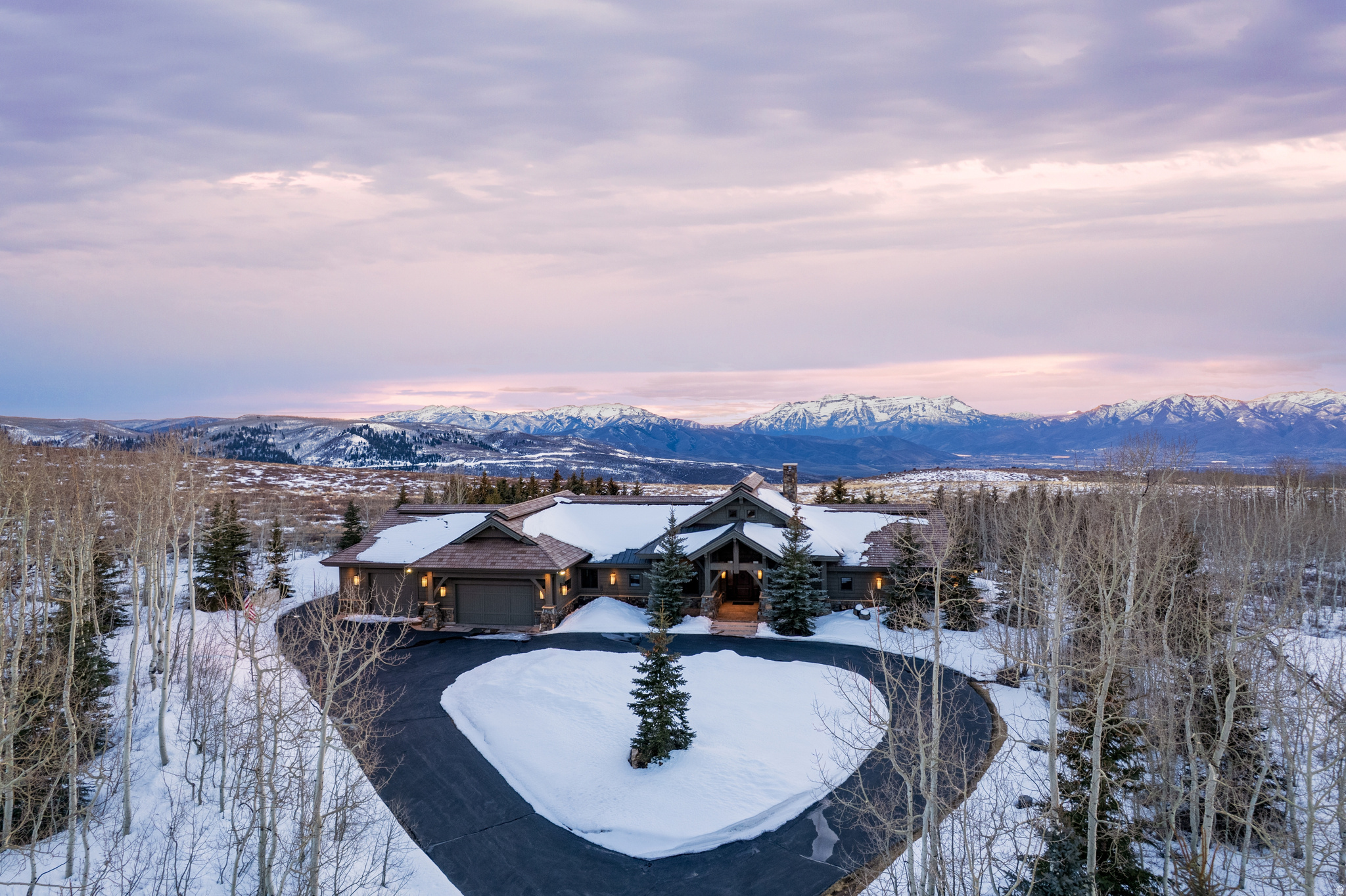 Set amid the aspens and pines of Wolf Creek Ranch, this coveted 160-acre legacy estate offers refined mountain living amid Utah's high-country beauty. The flat, fully fenced parcel features sweeping views of Mt. Timpanogos and a serene sense of privacy. The single-level home boasts four en-suite bedrooms, vaulted ceilings, and an open-concept layout that welcomes natural light and seamless indoor-outdoor living. Whether you're enjoying the stone fireplace in winter or watching elk roam at sunrise, the home is designed to embrace nature year-round. With room to build a barn, guest house, or yurt, and a close-knit community that values land and lifestyle, this property offers rare solitude without isolation.  Wolf Creek Ranch offers an unmatched lifestyle-a private, gated sanctuary with 60 miles of scenic trails for hiking, horseback riding, and winter adventures. Cast a line in private trout ponds, relax along the pristine Provo River, or unwind at the Ranch Center, complete with a community kitchen, fire pit, and owner's loft. Horse enthusiasts will appreciate the community's well-maintained equestrian facilities, offering a relaxed program with plenty of space to ride and explore the vast landscape. With a fuel center for ATVs and snowmobiles, every season brings new possibilities. Don't just dream about mountain living-experience it. Come see for yourself why Wolf Creek Ranch is where adventure meets serenity.
