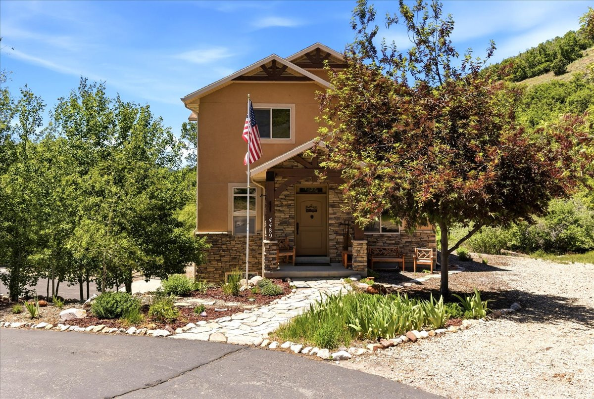 Stunning custom-built Peterson Builders home on a private 1.34-acre wooded lot along seasonal Wolf Creek, just minutes from Powder Mountain. This furnished 3-bedroom, 4 full-bath residence offers 3,648 total square feet, which includes two enclosed four-season porches, each approximately 300 SF, complete with heat and A/C for year-round enjoyment. Quality craftsmanship is evident throughout with blown insulation, custom hickory cabinetry in the kitchen, laundry room, and all four baths, quartz stone countertops, and beautiful log wood accents. The home features an inviting covered entry, circular drive, and a spacious 3-car garage the heated and air-conditioned single-car garage bay. with under-stair storage and pull-down attic access. Interior highlights include an extra-wide half-log stairway, large closets, private office, and a spacious laundry room with utility sink, built-in ironing board, and sewing center. The vaulted master suite showcases custom wooden beams, a gas fireplace with half-log mantel, and a luxurious bath featuring a body-jet shower. Additional half-log mantel accents are found in the living room. Designed for comfort and efficiency with two hot water heaters, a whole-house recirculating hot water system, two air handlers, and two A/C units. The Heat & Glo wood-burning fireplace in the living room is capable of heating the entire home. Outdoor amenities include two electrified sheds: a 14' x 16' shed and a 14' x 28' shed with two lofts and a workbench-ideal for storage, hobbies, or a workshop. A rare opportunity to own a beautifully crafted, move-in-ready custom home offering privacy, functionality, and timeless rustic elegance near world-class recreation.  All property information, boundaries and documents to be verified by buyer.