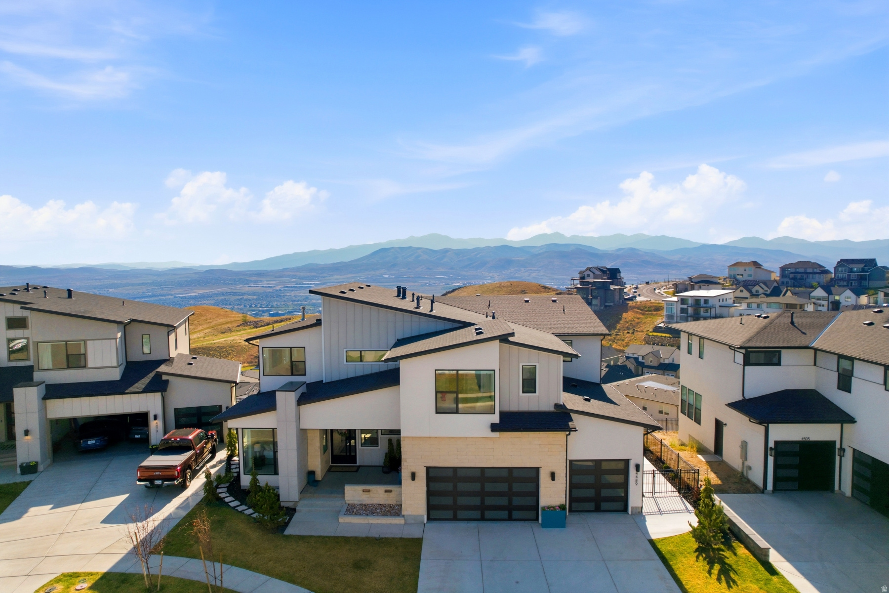 Welcome to your dream home at the top of Lakeview Estates, perched on one of the best premium view lots! This stunning property boasts breathtaking mountain, city, and lake views, offering amazing sunsets that will take your breath away. As you enter, you're greeted by a striking steel pivot door that leads you into a grand space featuring over 6,300 square feet of luxurious living. This home offers a four-car painted garage with epoxy flooring, providing ample space for your vehicles and storage. The heart of this home is a master chef's kitchen equipped with upgraded stacked wall cabinets, Jenn Air appliances, four ovens, two ice makers, and two dishwashers, making it perfect for culinary enthusiasts. The elegant interior finishes include upgraded bathroom fixtures, a master closet organizer, and lush padded carpeting throughout. Enjoy the spacious layout with six bedrooms, six bathrooms, and two powder baths, complemented by a lower-level family room featuring a full kitchen-ideal for entertaining. The upper primary bedroom offers stunning views, a cozy fireplace, and a luxurious primary shower with a soaking tub. Step outside to the covered main-level deck or explore the beautifully landscaped front and back yards, complete with stone stairs leading to additional patio areas and a fire pit for those magical evenings under the stars. With three fireplaces, high ceilings, and a floating main staircase, this home exudes elegance and comfort. The corner office provides a tranquil workspace with amazing views. Don't miss this opportunity to own a fully upgraded home with over $1M in enhancements, located in a top-of-the-hill premium location. Furniture is negotiable, making this a must-see home! Experience the magic of sunsets and twinkling evening lights-schedule your private showing today.
