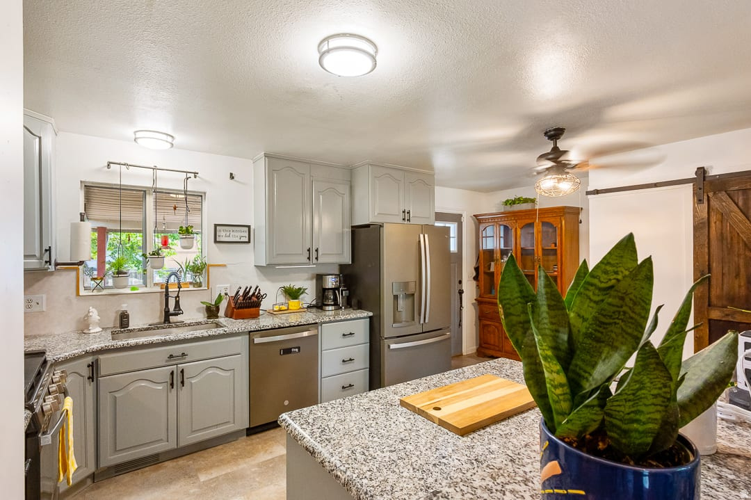 WELCOME HOME! This beautiful 4-bedroom, 2-bathroom retreat is filled with modern updates. The open floor plan offers the privacy and comfort you've been looking for with its fully fenced front & backyard! Updated kitchen features new LVP flooring, granite countertops, and a fresh, modern feel. New dishwasher & disposal. The basement has been refreshed with new paint and carpet, along with new vinyl flooring in the basement bathroom. Central air throughout.  Major updates provide peace of mind, including an HVAC system that is only three years old and a brand-new roof installed this year! The walkout basement offers convenient access with a mother-in-law apartment potential. Cold storage for all your canned goods in the basement. Large, spacious quarter-acre lot with full sprinkling system. Backyard provides endless possibilities for a garden, playground, pool, or even a pickleball court! Relax and take in the view from the covered backyard deck. The 2-car garage and double carport provides plenty of parking and storage space. Shed included to store your lawn mower & tools. There's even enough space for a small boat or trailer. This wonderful home on a quiet, tree-lined street COULD BE YOURS TODAY!