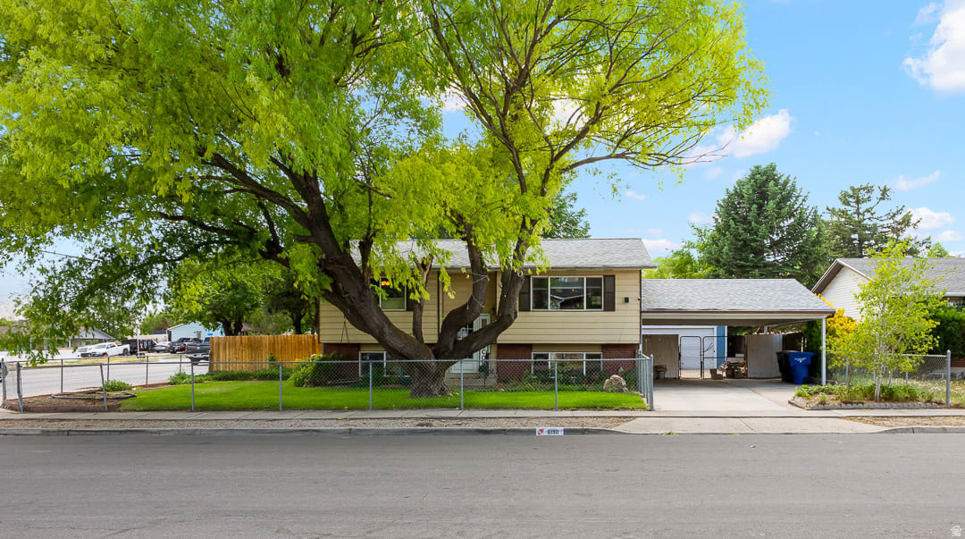 WELCOME HOME! This beautiful 4-bedroom, 2-bathroom retreat is filled with modern updates. The open floor plan offers the privacy and comfort you've been looking for with its fully fenced front & backyard! Updated kitchen features new LVP flooring, granite countertops, and a fresh, modern feel. New dishwasher & disposal. The basement has been refreshed with new paint and carpet, along with new vinyl flooring in the basement bathroom. Central air throughout.  Major updates provide peace of mind, including an HVAC system that is only three years old and a brand-new roof installed this year! The walkout basement offers convenient access with a mother-in-law apartment potential. Cold storage for all your canned goods in the basement. Large, spacious quarter-acre lot. Backyard provides endless possibilities for a garden, playground, pool, or even a pickleball court! Relax and take in the view from the covered backyard deck. The detached 2-car garage and double carport provides plenty of parking and storage space. Shed included to store your lawn mower & tools. There's even enough space for a small boat or trailer. This wonderful home on a quiet, tree-lined street COULD BE YOURS TODAY!