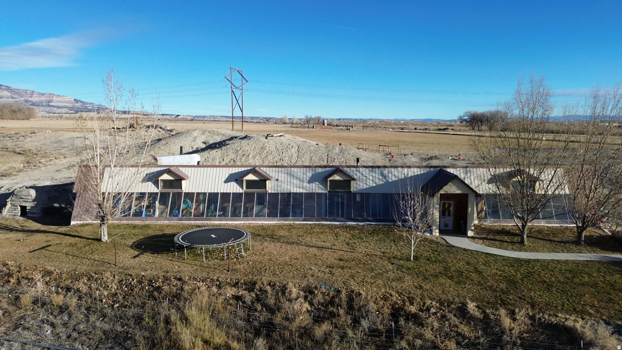 :  This incredible income-producing agricultural property is thoughtfully designed for self-sufficiency, comfort, and productivity. In addition to the main homestead, two separate agricultural parcels are available and may be purchased individually. Home Property: The main home parcel consists of approximately 9.47 acres. Every feature on the home property has been carefully maintained and upgraded to maximize function and long-term value. Home Features & Improvements: Dishwasher (new September 2025),Water heater (less than 1 year old), Cold storage: approximately 160 sq. ft., Septic system pumped and serviced September 2025, Energy efficiency upgrades include additional attic insulation and upgraded roof screws with roof-cap venting completed winter 2024, Garden & Orchard -acre fenced garden area with mature fruit trees including 2 apple, 2 peach, 1 pear, 1 apricot, and 1 pie cherry. Also features thriving blackberry, raspberry, and elderberry bushes. Deer have recently discovered the garden, so a deer fence is recommended to protect future harvests.,GreenhouseUsed for growing melons, peppers, culinary herbs, kale, medicinal herbs, and succulents.SaunaCustom-built wet/dry sauna with natural rock seating and flooring, offering a unique and relaxing retreat. Minor upkeep is needed to maintain the soil cover on the roof. Accessory Dwelling Unit (ADU)  Studio Apartment 384 sq. ft. with a galley kitchen (refrigerator and electric stove), one bathroom, and washer/dryer hookups. Heated and cooled by a ductless heat pump installed in 2015. Ideal for guests, extended family, or rental income. Insulated Cold Storage 8 x 8 (64 sq. ft.) refrigerated space built into the end of a 40-foot shipping container. Cooled with a Cool-Bot and A/C unit, this is perfect for produce or meat storage. Agricultural & Utility Buildings: Dairy Barn with Apartment 54 x 16 (864 sq. ft. total; 384 sq. ft. 8-foot ceilings in the milking area and sink room, 11-foot ceilings in the apartment. Tile floors with drains throughout. Separate septic system emptied September 2025. Large Hay, Grain & Mechanic Pipe Barn 144 x 63 (9,072 sq. ft.), half cement floor, built in 2025. Ceiling height is 15.5 feet on the cement side and 20 feet on the hay storage side. Metal Insulated Shop (north side of large barn)28 x 26 (approximately 728 sq. ft.) with 11-foot ceilings. Built in 2008. Half workshop and half storage with built-in shelving. Equipped with 220 and 110 power and culinary water. Dog Kennels Six total kennels, including four small and two large, suitable for dogs or small animals. Chicken Coop with Run Ready for fresh eggs daily. Parcel #: 03-0046-0032 Acres: 25.910 2024 taxes - $86.64 North West Field Secondary water lines are located at the dog kennels (east side), the corral pen, east of the large barn, and the frost-free troughs in the corrals and fields behind the house. Sprinkler System. Secondary water supplies the garden and home lawn. Culinary water is available inside the dairy barn, apartment, insulated shop, from the frost-free spigot in front of the home, and in the indoor grow box. Water Line Maps: Detailed property maps show all water line locations for easy maintenance. Additional Land for Sale  Sold Separately Home fields are divided into 3: Parcel #: 03-0046-0028 Acres: 23.630 2024 Taxes: $70.01. This field is in a strong grass/alfalfa mix with a good stand. Grass was planted this spring alongside established alfalfa. A tire stock water trough is located in the northwest corner of the field. The property includes one wheel line and one short-hand line. Irrigation lines were installed around 2014. East Field Parcel #: 03-0045-0015 Acres: 40.770 2024 Taxes: $91.99 New alfalfa was planted in the fall of 2024, creating an excellent, thick stand. The field has a stock water line but no trough. It is equipped with two wheel lines installed in 2013. Water Rights144 B shares and 90 A shares with Huntington Cleveland Irrigation. Square footage figures are