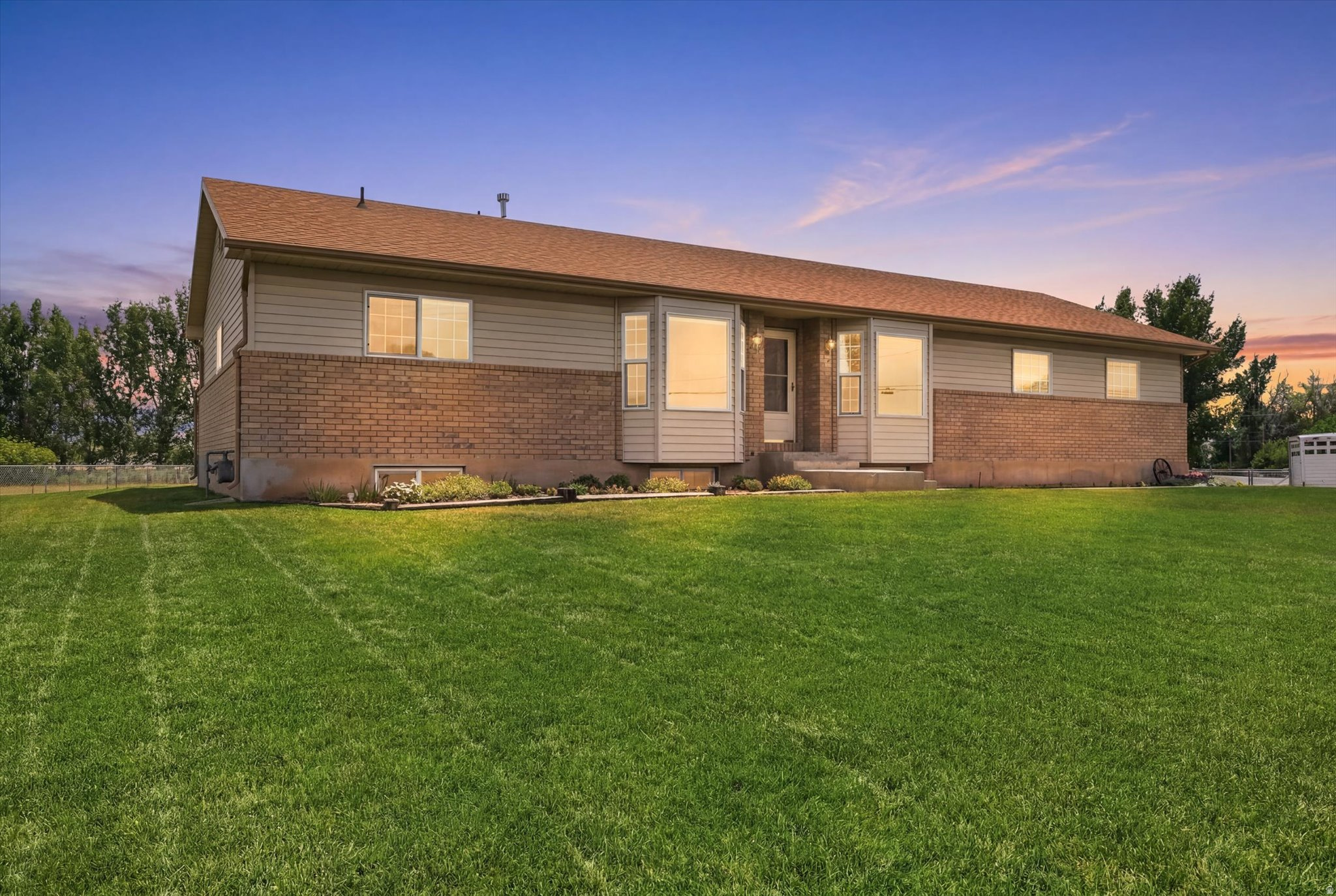 This charming ranch style rambler offeris the perfect blend of country living, while be minutes from modern convenience. Situated on 1 acre, the property is setup for those that desire animals or just a little extra elbow room.  Many outbuildings such as a Garden Shed (10x14), Equipment Shed (13'6x16'), Hay Shed is (18'x20'), and the Shed w'feeder (11'x14'), not to mention the Garage (27'6x23' w'220 power).   The patio provides endless options for outdoor entertainment such as enjoying the morning sunrise or the afternoon shade for BBQ's. A beautifully landscaped yard w'garden spot defined and well done retaining walls, providing depth and personality to the lot. Inside you will find a home that has been loved by its original owners for many years. Full of natural light and an easy layout provide many spaces to enjoy and make it your own. Half bath and laundry right off the 2 car garage and brand new carpet in the lower level rec room and family room.  Out your kitchen window you can view the backyard scenery and walk out to the patio from the spacious dining area. Many be subdividing potential. Check with the city. Come take a look!