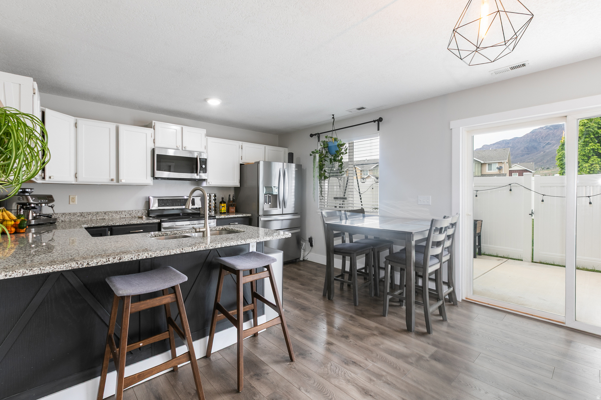 This updated Harrisville townhome offers a combination of price, space, and low-maintenance living, with a private enclosed patio perfect for relaxing or entertaining.  Enjoy the mountain views from the patio!  Freshly repainted kitchen cabinets in this spacious kitchen with ample counter space.  3 bedrooms, updated baths, and tons of natural light! Enjoy low maintenance living with HOA amenities and convenient commute on I-15, as well as near shopping, dining, and the aquatic center. The owners have put a lot of love into the home and it's now ready for a new homeowner. Check out the virtual tour!