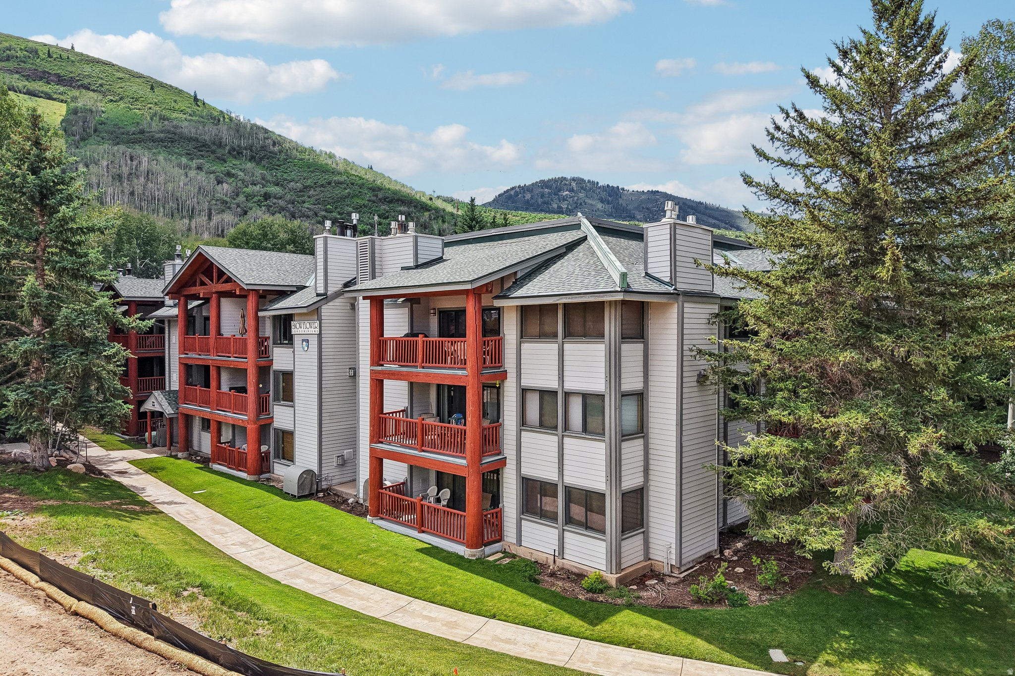 Experience the ultimate Park City lifestyle from this beautifully renovated 2-bedroom, 2-bath ski-in/ski-out residence located just steps from the First Time Lift at Park City Mountain. Perfectly positioned for year-round adventure, you'll enjoy effortless access to world-class skiing, mountain biking, hiking trails, golf, shopping, restaurants, and everything Park City has to offer. Thoughtfully updated with timeless mountain finishes, the inviting interior blends comfort and style. The spacious open-concept living area is filled with natural light from expansive windows that frame peaceful aspen views, creating a warm and relaxing atmosphere after a day on the slopes. The beautifully updated kitchen flows seamlessly into the dining area, making it ideal for entertaining family and friends. A generous living room with a cozy fireplace and queen sleeper sofa provides additional accommodations while maintaining an open, welcoming feel. The corner primary suite offers a private retreat surrounded by mature aspens and features an ensuite bath with an oversized vanity and tub/shower combination. A well-appointed guest bedroom and second full bath provide comfortable space for family and visitors. Snow Flower is one of Park City's premier slopeside communities, offering exceptional resort-style amenities including two heated swimming pools, a large hot tub, fitness center, ski lockers, underground parking, bike storage, tennis and pickleball courts, BBQ and picnic areas, and convenient laundry facilities in each building. Whether you're searching for a full-time mountain residence, a vacation getaway, or a strong investment opportunity, this turnkey condominium delivers the perfect combination of true ski-in/ski-out convenience, tasteful renovations, outstanding amenities, and an unbeatable location in the heart of Park City.