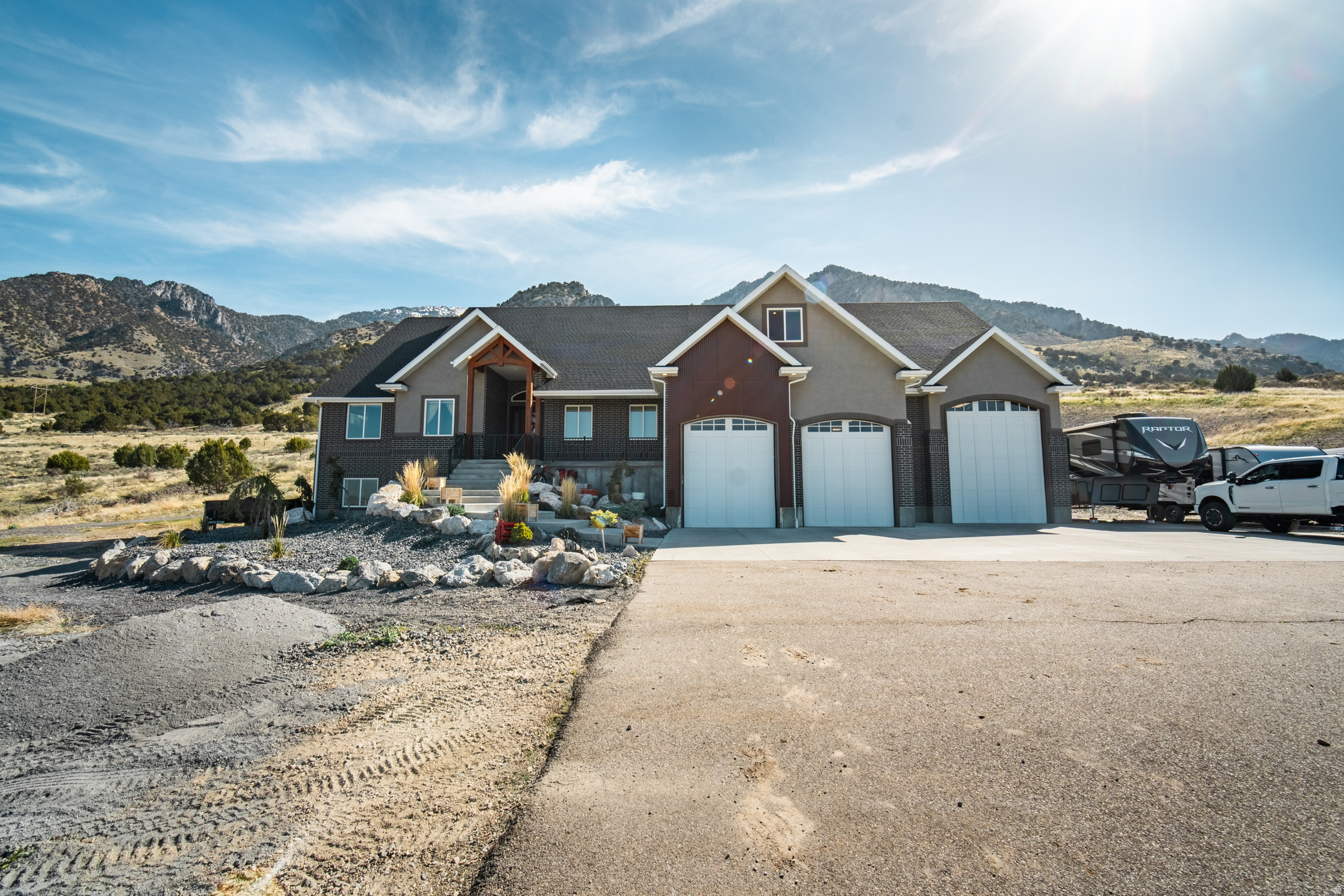 Experience unmatched country living with this one-of-a-kind property featuring a private dirt bike track, expansive pasture ground, and direct access to hiking and riding trails leading into the canyon. Take in sweeping views of Box Elder County from picture windows that frame the natural beauty. Inside, a thoughtful layout offers a hidden butler's pantry, spacious entertaining areas, and a luxurious primary suite with his-and-hers closets, a walk-in shower, and a soaker tub with a view. Enjoy large bedrooms, multiple gathering spaces, a walk-out basement with apartment potential, in-home gym, walk-in safe, oversized RV garage, and abundant storage throughout. This property offers so much and is move in ready, you really must see it in person!  Square footage figures are provided as a courtesy estimate only and were obtained from county records.  Buyer is advised to obtain an independent measurement.