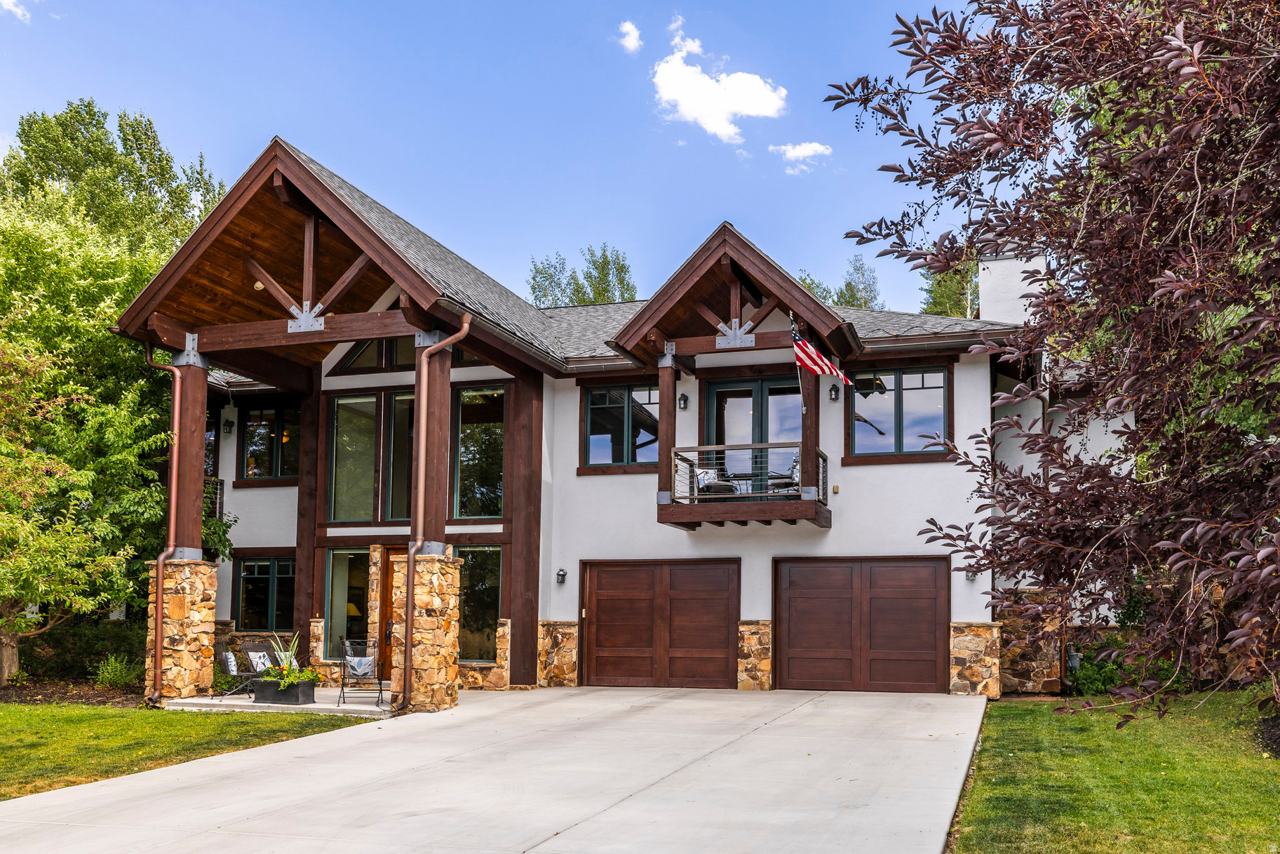 Discover timeless mountain living in this beautifully updated home in Park City's quiet and coveted Chatham Hills neighborhood. This stunning 4-bedroom, 4-bathroom home offers 4,809 square feet of thoughtfully designed living space on a beautifully landscaped 0.34-acre lot. Surrounded by open space in both the front and back, this residence offers the perfect blend of comfort, privacy, and access to nature. Step inside to find warmth and charm with exposed timber beams, vaulted ceilings, and rich hardwood floors. Natural light fills the spacious great room, where a dramatic fireplace creates a inviting gathering space. The gourmet kitchen is a chef's dream, featuring a 6-burner range, large island, and generous prep and storage space - perfect for entertaining. The main-level master suite is a serene retreat, complete with its own fireplace, private patio, and a beautifully updated ensuite bathroom boasting heated floors, a soaking tub, and a walk-in shower. Downstairs, the expansive family room with a second fireplace and bar offers the perfect space for relaxing or hosting guests. Step outside to enjoy peaceful evenings on the back patio, surrounded by mature landscaping and the quiet of nature. Out the front door you will find direct access to the Rail Trail-ideal for biking, hiking, cross country skiing and year-round outdoor enjoyment. Additional highlights include a new roof, central vacuum, new concrete driveway, and an oversized 3-car garage with room for all your gear and extra storage. This home truly has it all-style, space, serenity, and unmatched access to Park City's outdoor lifestyle.