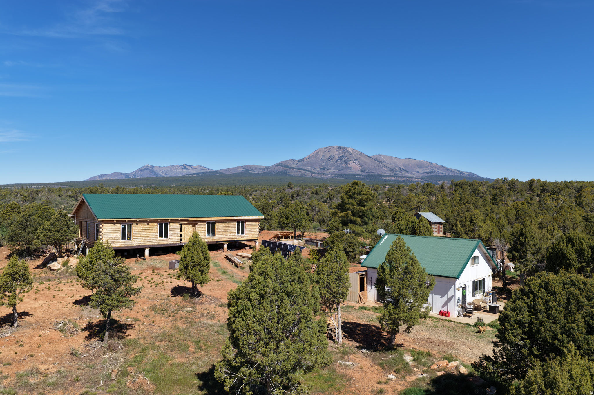 Ultimate Off-Grid Paradise Near Moab  Two Cabins on 7.5 Acres! PRICE IMPROVEMENT! Motivated sellers relocating out of state are ready to make a deal. Priced for an immediate, hassle-free cash sale, they are also open to flexible seller financing terms. Nestled against the dramatic red rock rim of Monticello, Utah, this prime horse property features 7.5 private, heavily wooded acres with majestic mountain views and instant access to endless BLM canyonlands. The main residence is a beautifully crafted, 2,100 sq. ft. log home. The unfinished interior allows you to finish the interior to your exact taste, build immediate sweat equity, and realize its full potential. The property also features a separate, disconnected 1,150 sq. ft. secondary cabin perfect for a guest home, workshop, or studio. Skip utility headaches with turnkey, self-reliant infrastructure, including a high-producing private 360-foot water well, septic tank, and robust off-grid solar power system. Property sold strictly As-Is for a fast closing. Secondary cabin carries zero financial value in the list price. Buyers to verify all information. Act fast-this versatile property will not last!