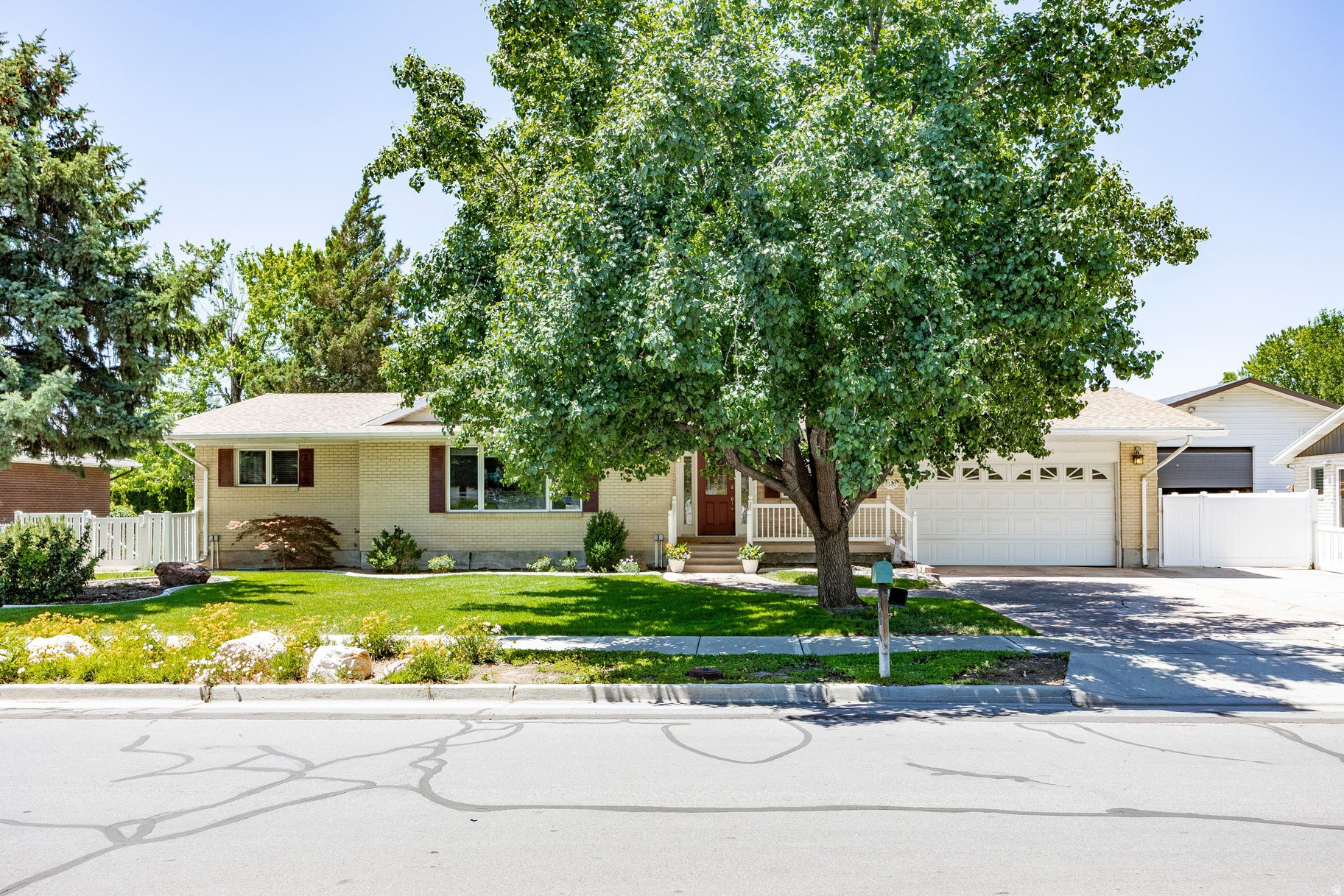 Nestled on a beautifully landscaped quarter-acre lot, this inviting 1970s residence offers the perfect blend of timeless character and thoughtful updates. The well-designed floor plan features two bedrooms upstairs, including a spacious primary suite complete with an ensuite bathroom and generous walk-in closet. New carpet throughout the upper level, updated kitchen countertops, and an open, functional main-level living area create a warm and welcoming atmosphere that's ready to enjoy. Step outside to discover a private garden oasis, where vibrant poppies, fragrant roses, and mature landscaping create a peaceful and picturesque retreat. The expansive backyard offers ample space to entertain, garden, play, or simply unwind and enjoy the serenity of your surroundings. With its lush outdoor spaces, inviting interior, and endless potential to make it your own, this delightful home is ready to welcome its next owner.