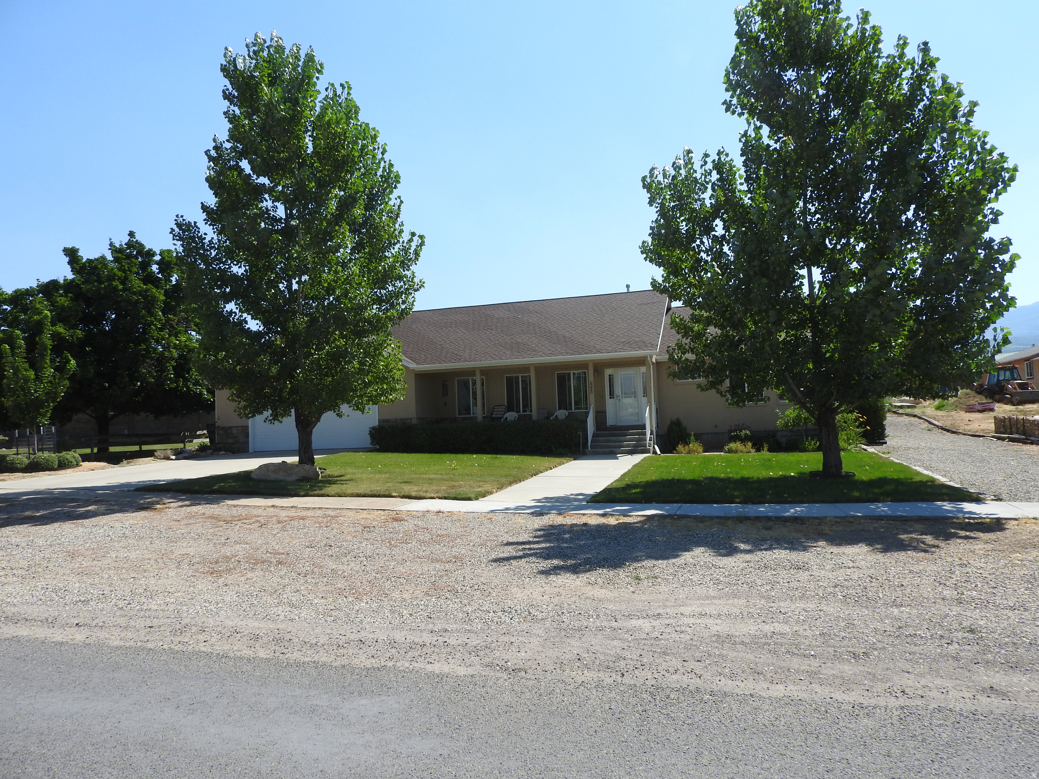 Nice home with an attached 800 sf heated shop and over sized deep 2 car garage. Covered basement entry. Well taken care of with lots of storage. Fenced garden, orchard and chicken run with pressuirzed irrigation. Two sheds. Wood burning stove downstairs with a full wood shed on the patio. Half acre lot with great nieghbors! Quiet. Two blocks from elementary and high school. The heated shop square footage is not included in overall square footage of the house. Use it as a shop, craft room, huge famly room or split into 2 or 3 individual rooms. This home offers lots of closets and storage areas. You must see to apprecaite/call to make an appointment to view. Square footage figures are provided as a courtesy estimate only and was obtained through county records. Buyer is advised to obtain an independent measurement and verify all information.
