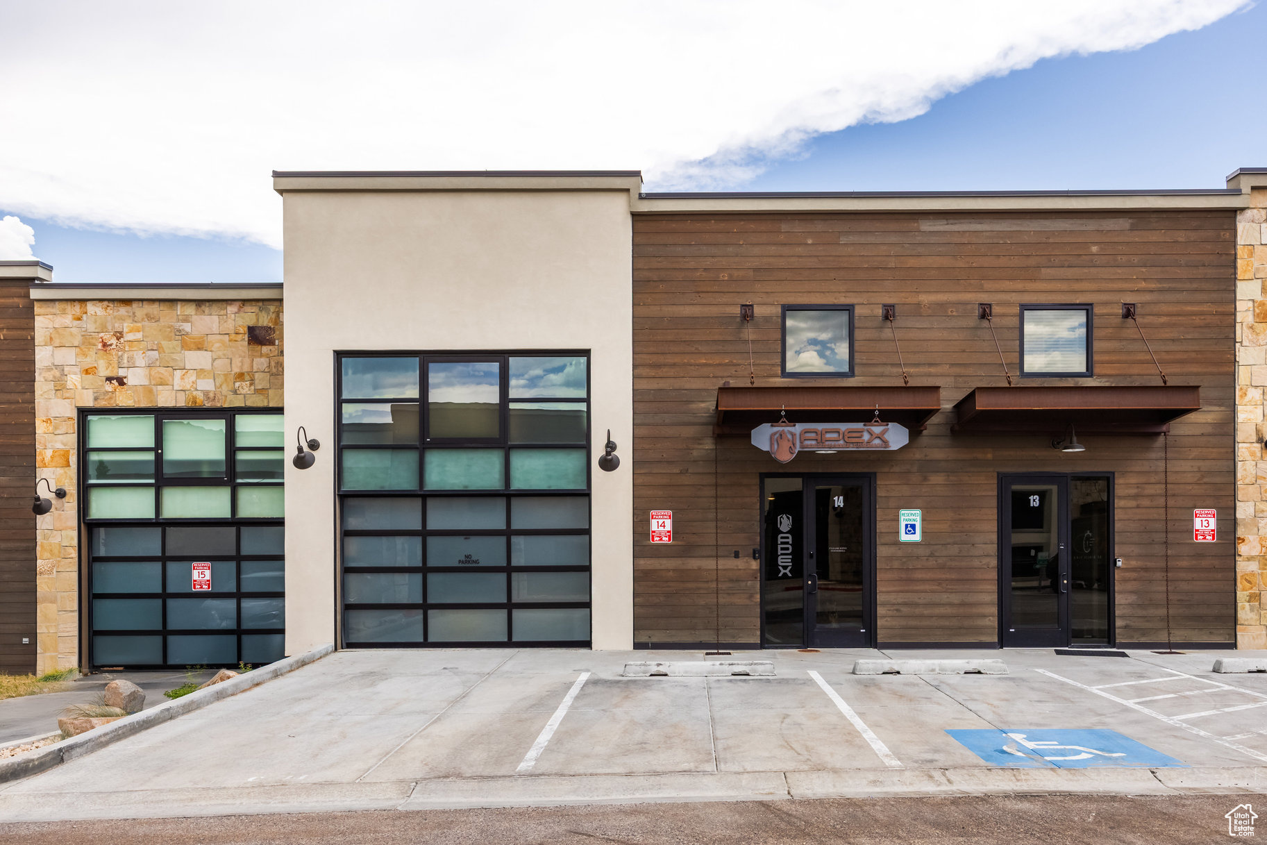 Discover a truly unique opportunity in Park City's Park East II & III Business Community. This modern, mixed-use property is designed for today's "live, work, play" lifestyle, offering 4,600 square feet across three well-planned levels with exceptional flexibility. Zoned for light industrial use, it supports a wide range of commercial, residential, and creative possibilities. The main level features a spacious commercial area with soaring ceilings, a full bathroom, gas heat, 3-phase power, and a large 3-car garage with the potential to accommodate a fourth vehicle or side-by-side parking. It's perfectly suited for a showroom, workshop, studio, or professional workspace. The lower level adds even more versatility with additional office, commercial, or storage space to support your operations or future expansion. Upstairs, a fully approved ADU offers a contemporary studio-style residence with a full kitchen, open living and sleeping area, and a full bathroom-ideal for an owner-user, executive suite, or income-producing long term rental. Throughout the property, custom steelwork highlights the modern industrial design while maintaining a clean, functional aesthetic. Importantly, the space has been thoughtfully designed without being overbuilt, allowing the next owner the freedom to further customize, expand, or adapt the layout as needs evolve. Additional highlights include two assigned parking spaces and a private rooftop deck with a hot tub, creating an exceptional setting for entertaining, relaxing, or hosting clients. Located just minutes from Park City's Historic Main Street, with quick access to Highway 40 and Salt Lake City International Airport, this one-of-a-kind property blends location, design, and versatility into a rare offering with endless potential.