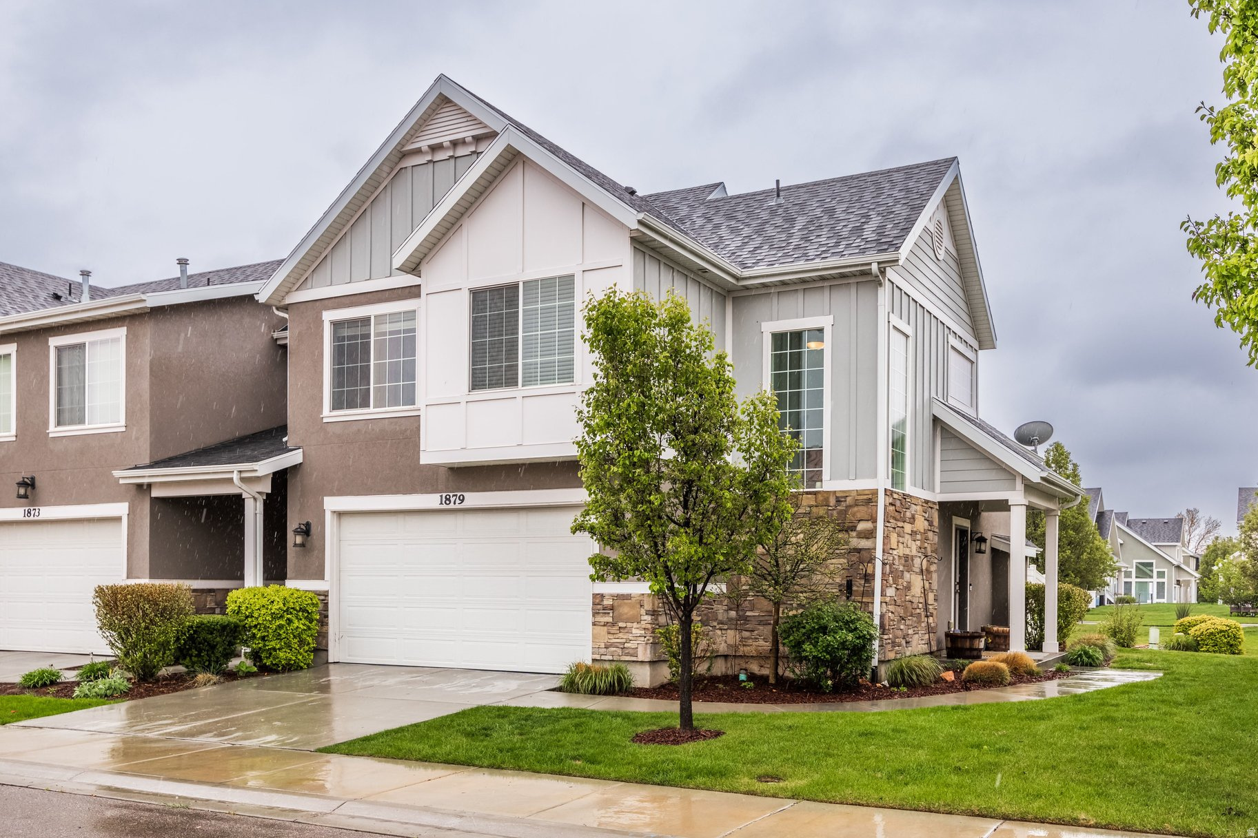 This light-filled home offers an open layout, quality design, and low-maintenance living in a well-kept, centrally-located Riverton neighborhood. As one of a two-unit townhouse row with each entrance staggered around a corner, this unit lives like a standalone with a fenced backyard. 3 bd, 2.5 bath and 2 car garage over two levels with durable finishes in timeless shades. KITCHEN: granite countertops, abundant storage plus pantry, double sink in breakfast bar island, elegant dark wood toned cabinetry, and informal dining anchored by a 4-light chandelier. LIVING ROOM: space enough for a sectional sofa, tall vaulted ceilings, ample light from opening and fixed windows, gas fireplace with white stone and shiplap accents with wooden mantle, large entrance area with under-stairs storage (or toy room), and corner staircase with soaring windows and refined cast-iron railing. YARD: Fenced backyard with new sod, and covered raised patio. GARAGE: 2-car with epoxy floor coating, opens into a tiled foyer at the kitchen with large double door coat closet and powder room. PRIMARY BEDROOM: Large suite upstairs with vaulted ceiling and fan, plenty of room for a king bed and bedside tables, en suite bath with walk-in closet, dual vanities in a granite countertop, contemporary fixtures, large tub and separate granite shower stall. BEDROOMS: 2 more bedrooms upstairs with closets, opening windows and great light, and share a full bath with tub and shower. LAUNDRY: Large closet upstairs with room for side-by-side washer and dryer with additional storage space above and tiled floor below. LOW MAINTENANCE: HOA maintains landscaping and watering inside and outside the fence. LOCATION: Located in Riverton on the south end of the Salt Lake Valley, this home offers convenient access to dining, shopping, fitness, Riverton City Park and Library, and allows for an easy commute in multiple directions or an ideal setup for working from home. Community amenities include walking path and playground.