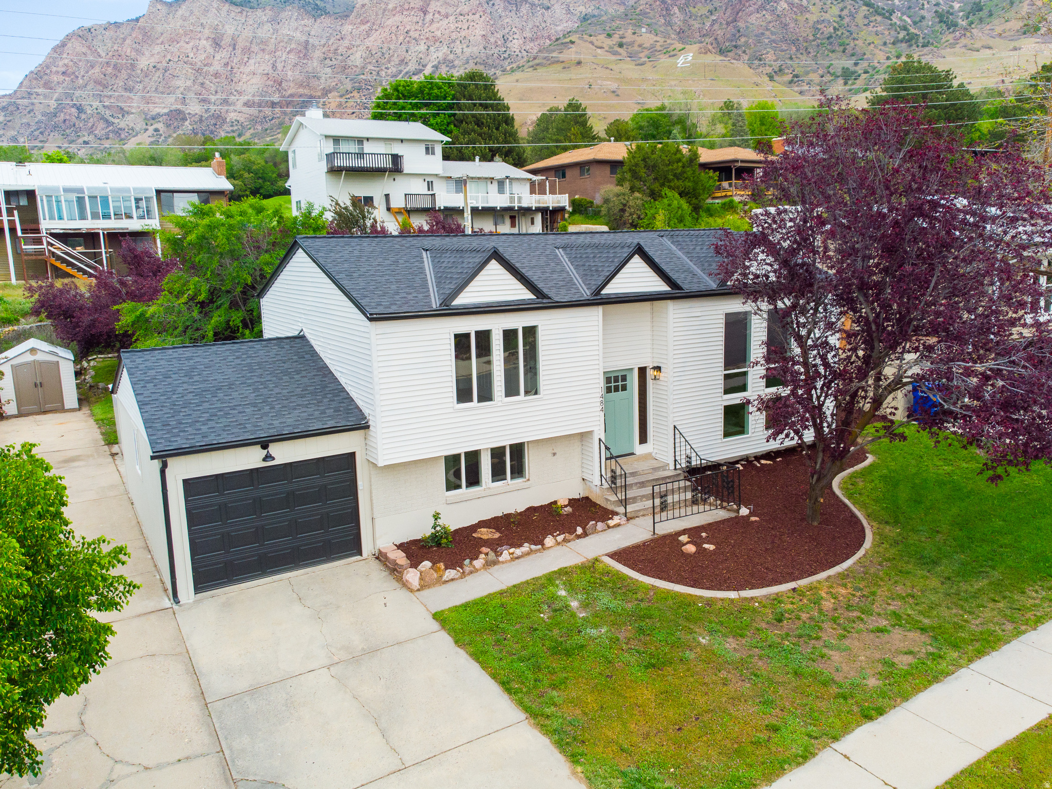 Completely transformed East Ogden home with a fresh designer vision! This property delivers a stunning top-to-bottom renovation with style and function in every detail! The exterior makes a bold first impression with designer paint fresh landscaping, and all-new windows, while inside you'll find a fully re-imagined and comfortable living space. The interior shines with a cohesive designer palette, custom handrails & banisters, plush new carpet, LVP flowing throughout, tile flooring, and modern lighting fixtures. The kitchen is a showstopper with new cabinetry, quartz countertops, tile backsplash, and all new stainless steel appliances, while the bathrooms feel like a luxury retreat with new tubs, vanities, mirrors, and striking custom tile work. Custom tile details also elevate the fireplace, adding a unique focal point to the living space. Large deck off the back of the house is great for entertaining and relaxing in the evenings. Every element has been thoughtfully curated by a professional designer, creating a polished, move-in-ready home that blends comfort, quality, and elevated design.