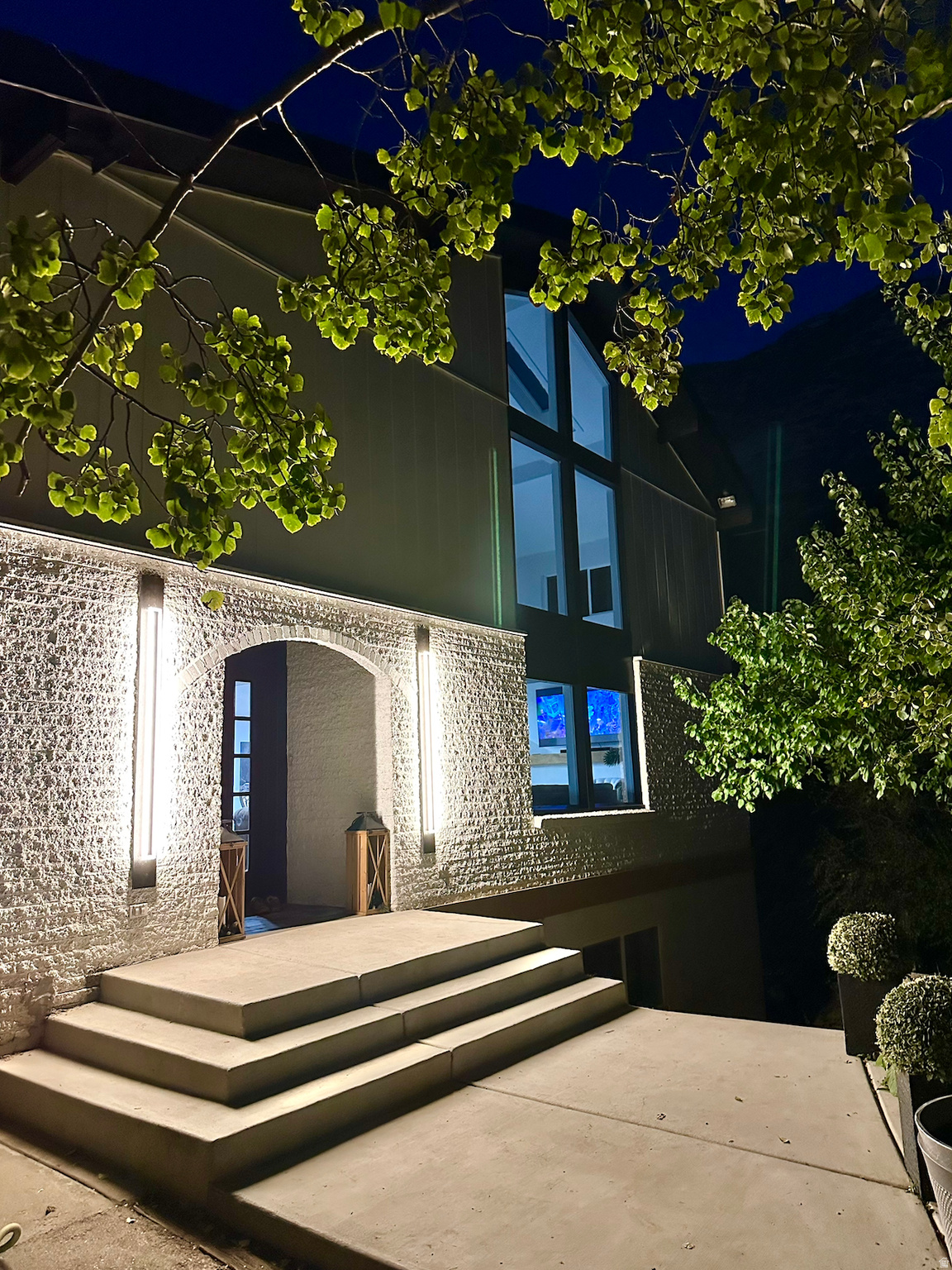 This beautifully remodeled home sits hidden, tucked away on a serene wooded lot in the corner of a cul-de-sac. Neighbors refer to the secluded grove as a fairy garden! The view from every window is a green oasis. With new quartz countertops, luxury vinyl floors, and lush new carpet, this home gives you all the benefits of modern construction with the unbeatable privacy afforded by the forested glen that surrounds you.  Front door features a beautiful stained glass window, created to match the allium that are in bloom in the photos. Kitchen has both electric and gas cooktops: The countertop of the bar is removable and reveals the gas cooktop underneath, so if gas cooking is your thing, you have both options available! The great room boasts an incredible 23 ft. vaulted ceiling with a second story loft. The loft even has a loft! The enormous primary bedroom has a gold and marble ensuite bathroom that overlooks the trees on the east side. This home has three decks: A private upper west deck and a lower east deck which leads out to the back north corner of the home where there is a deck and gas/power for a hot tub. Basement theater room is wired for a high-end speaker system and projector. The grounds have over 200 trees including apple, apricot, cherry plum, walnut, elm, aspen, scrub oak, maple, and golden rain trees. Raspberries line the top level of the wooded grove on the south of the home. Basement ADU is currently rented for $1480 a month on a contract that ends in July with an option for renewal at the buyers' discretion. Square footage figures are provided as a courtesy estimate only and were obtained from previous listing. Buyer is advised to obtain an independent measurement.