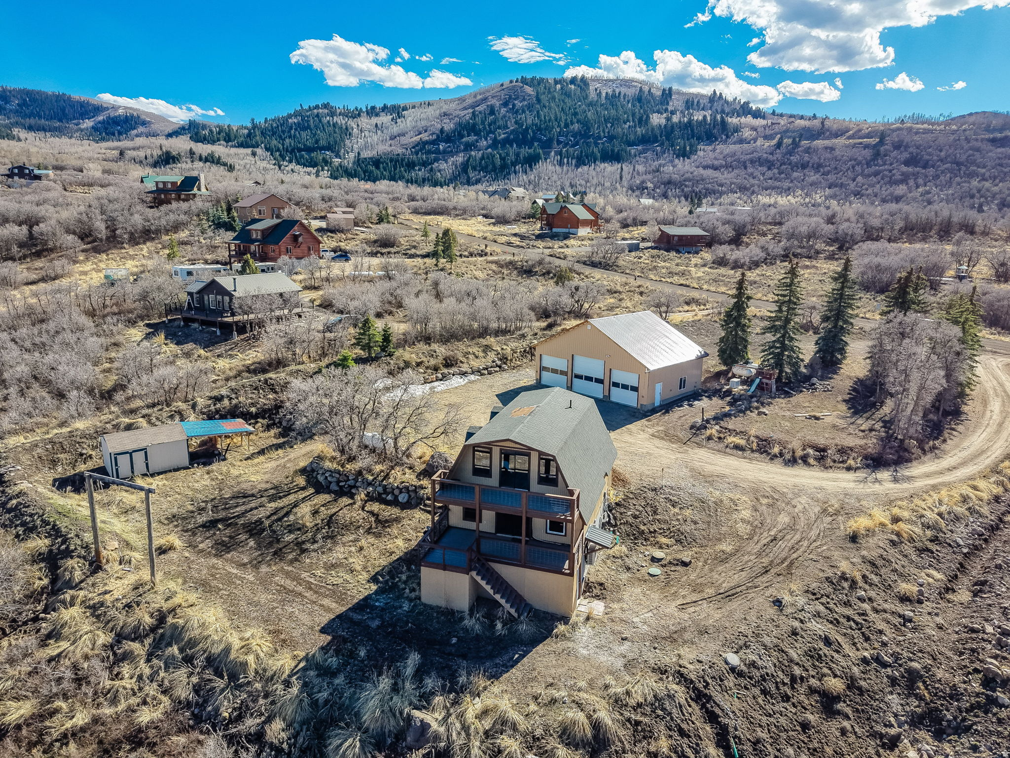 This one-of-a-kind A-frame cabin captures breathtaking mountain and lake views and features an oversized 42' x 30' detached, heated garage/workshop perfect for projects, storage, and more. Ideally situated mid-mountain on 1.2 acres, the property offers plenty of parking along with room for all your toys, RVs, and equipment. The kitchen has been thoughtfully updated with a large island, butcher block countertops, beautiful backsplash, new stainless steel appliances, and attractive LVP flooring. The lower level is spacious and open with basement entrance, ideal for guests or additional living space. Enjoy ample enclosed storage space under the deck. Upstairs, you'll find brand-new carpet, charming shiplap accents, and an expanded deck where you can soak in the incredible views. The home is equipped with efficient mini-splits for both heating and cooling, along with two 500-gallon propane tanks and an additional 300-gallon tank servicing the garage. Brand new state-of-the-art 2000 gallon septic tank, 24KW Generac generator, on-demand water heater, 100amp in house & garage, and radon mitigation system. Located in beautiful Timber Lakes where you'll enjoy gorgeous VIEWS, wildlife, year-round access and endless outdoor recreation right outside your door, including golf, skiing, snowmobiling, hiking, hunting, mountain biking, ATV riding, and more. Conveniently just 55 minutes from the SLC airport and a short drive to the amenities of Heber Valley and Park City, this property offers the perfect balance of adventure and accessibility!