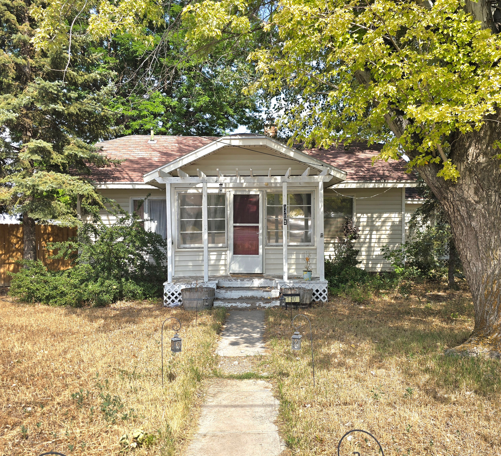 Cute cottage style home with a cute covered front porch that currently poses as a nail salon, lots of parking and several trees for ample shade and privacy. It has an Apple and apricot tree. Several outbuildings and carpot for covered parking.