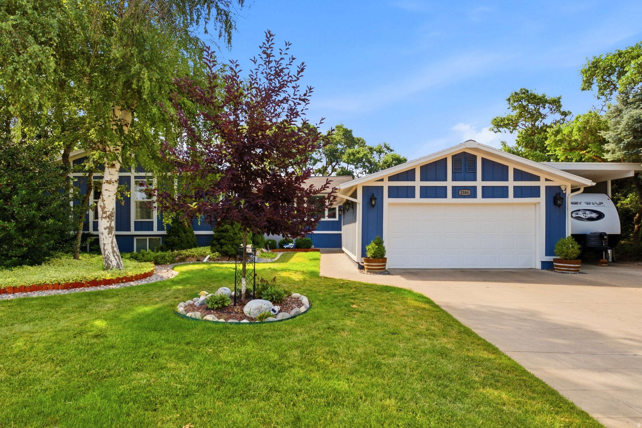 JUST LISTED in East Layton! Looking for the perfect mix of mountain views and an indoor/outdoor entertainment paradise? This stunning 3,396 sq. ft. rambler sits on a private, terraced .52-acre lot and truly has it all!   WHY YOU'LL LOVE THE INSIDE: Space to Grow:4 spacious bedrooms and 3 bathrooms. Office, Den, Exercise Room Work from Home:Main floor office with gorgeous custom-built cabinetry. Double the Cozy:2 huge family rooms, each featuring a gas log fireplace. The Ultimate Retreat:Basement "Man Cave" complete with a wet bar and more custom built-ins. Fresh Updates:Brand new paint and updated flooring throughout.  WHY YOU'LL LOVE THE OUTSIDE: BBQ Heaven:Custom (2020) Trex deck perfect for entertaining and soaking in those breathtaking mountain views. Your Own Orchard:A terraced backyard with flat play areas, raised garden beds, walk out basement, covered patio, and an additional patio with swings The Dream Shop:A 20'x13' heated detached woodshop or home gym with a roller door into the 2-car garage. Parking Galore:Detached 2-car garage plus a 16' Tall x 13' Wide Covered RV Port This East Layton gem won't last long. Welcome home!