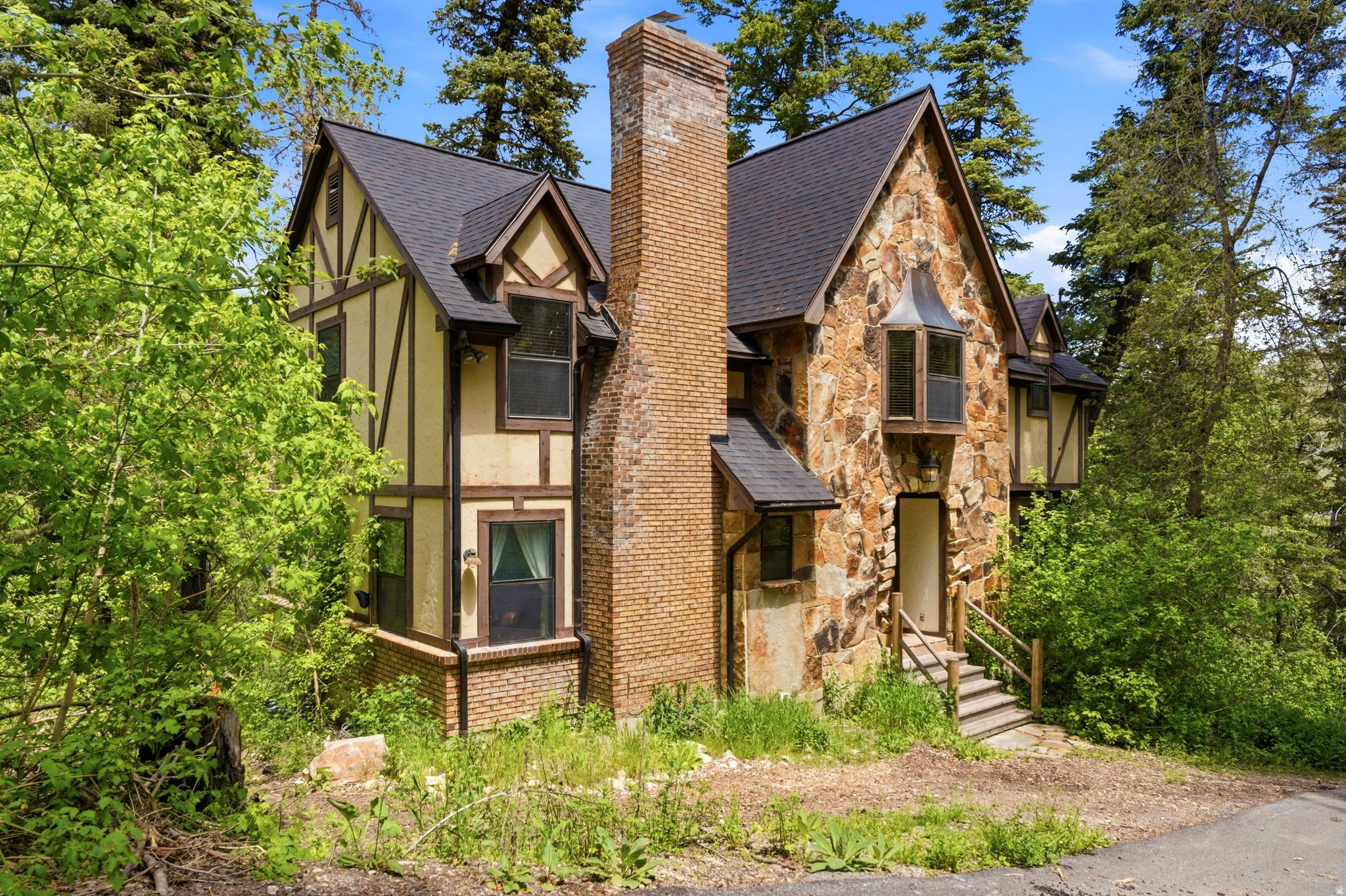 Hidden within the gated Brickerhaven community near Sundance, this charming 5-bedroom Tudor-style mountain cabin offers a rare opportunity to own a secluded retreat surrounded by nature. Approximately 3,300 square feet across three levels, the home provides ample space for gathering, relaxing, and enjoying the mountain setting.  Residents enjoy access to community amenities including a children's playground, scenic beaver ponds, abundant wildlife, and private trail access leading toward Stewart Falls. The Sundance Resort is just minutes away, offering year-round recreation, dining, and outdoor adventure.  Brickerhaven is a private, gated community where short-term rentals are not permitted, preserving the peaceful residential character of the neighborhood. Property is being sold as-is and fully furnished.