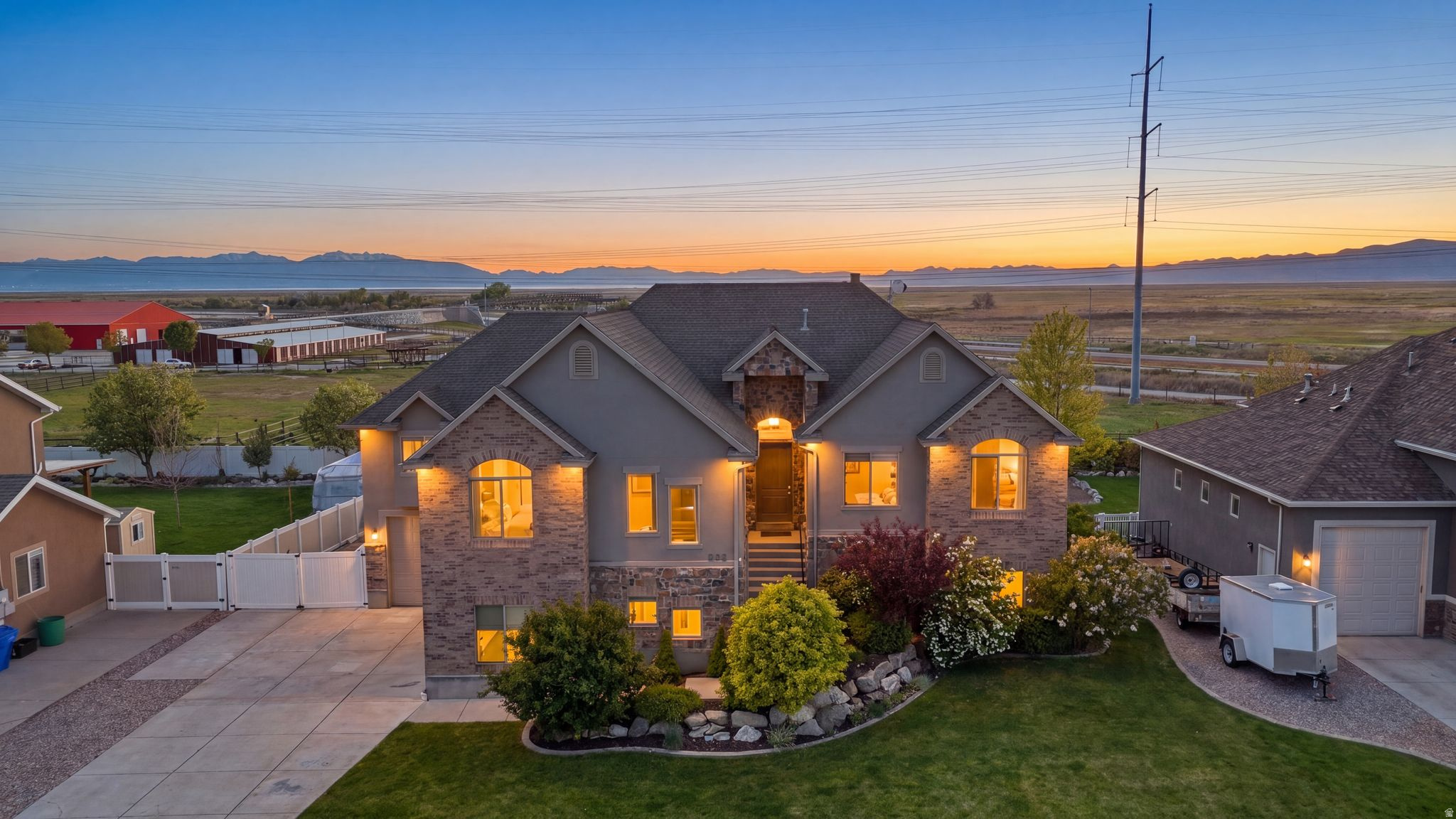Welcome to 223 N Ranch Rd in The Farmington Ranches subdivision - a light-filled 6-bedroom, 5.5-bath home offering 4,676 sq ft, mountain and sunset views, a walkout daylight basement, generous RV parking, and a fully fenced flat backyard with fruit trees. Priced at $1,129,900, this home delivers space, views, and move-in-ready livability in one of Farmington's most convenient neighborhoods near Station Park, top-rated schools, and a quick 25-minute commute to downtown Salt Lake City or the airport.  The home features a spacious kitchen with white cabinets, stainless steel appliances and quartz counter tops.   A great room off of the kitchen with a fireplace and vaulted ceilings.   A covered deck is located just off of the kitchen with views out to the west. A primary suite that is large enough for a king sized bed, a primary bathroom with a double vanity, separate shower and jetted tub and a walk-in closet.    There is an additional more casual family room on the main floor that is perfect for large gatherings.   There are four additional bedrooms and two more bathrooms on this main floor. Downstairs you will enjoy the light and open feeling that the daylight and walkout basement provide.   No window wells in this home.  Everything is above grade.   A wet bar with a cook top is connected to the family room along with a lot of extra space for game tables etc.  Surround sound and built in speakers are all ready for your entertaining.  One bedroom with an on-suite down in the basement.   Tankless water heater, epoxy floors in the garage, generous RV Parking space for any toys that you may have, a flat backyard that is fully fenced a number of fruit trees.