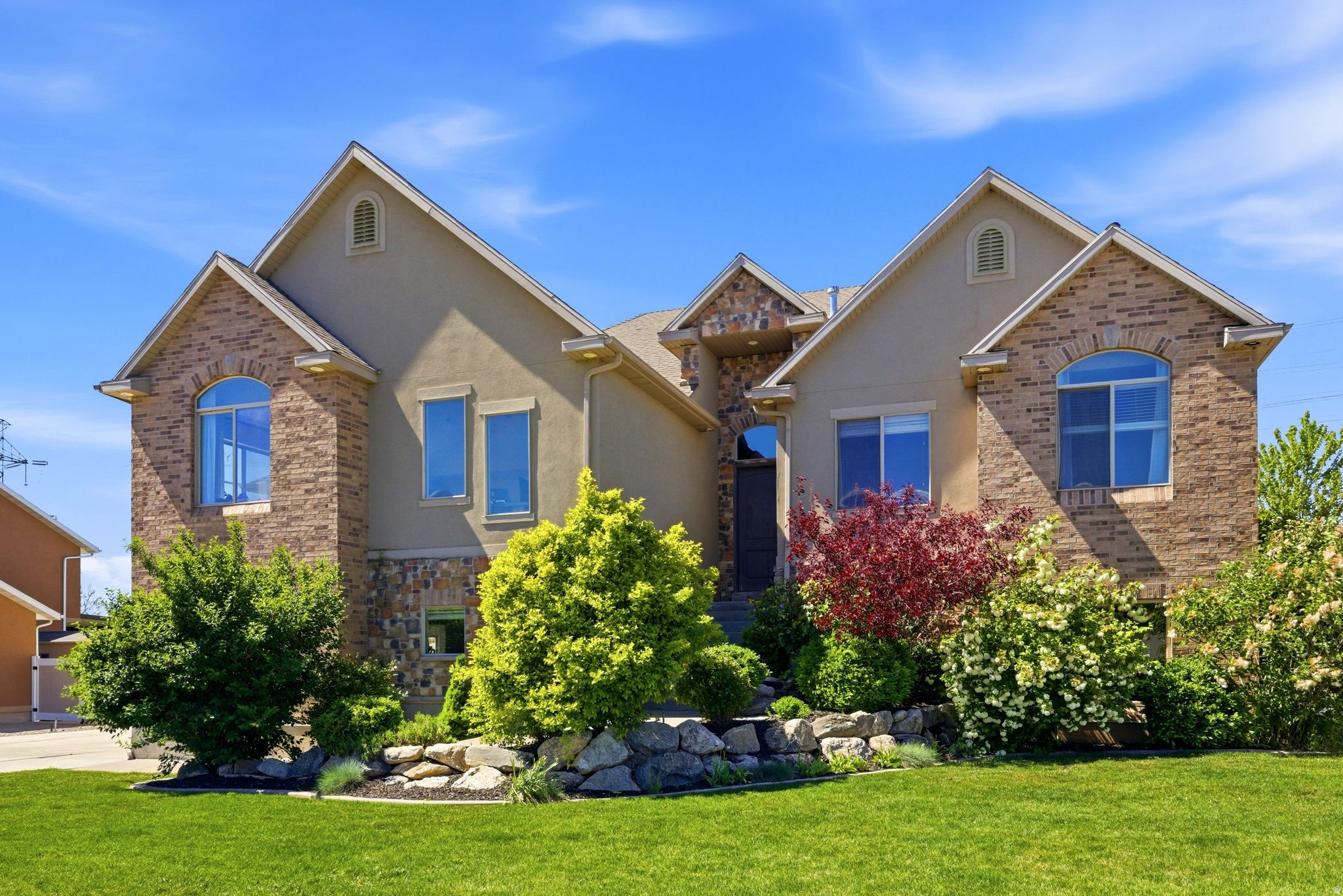 Welcome to 223 N Ranch Rd in The Farmington Ranches subdivision - a light-filled 6-bedroom, 5.5-bath home offering 4,676 sq ft, mountain and sunset views, a walkout daylight basement, generous RV parking, and a fully fenced flat backyard with fruit trees. Priced at $1,125,000 this home delivers space, views, and move-in-ready livability in one of Farmington's most convenient neighborhoods near Station Park, top-rated schools, and a quick 25-minute commute to downtown Salt Lake City or the airport.  The home features a spacious kitchen with white cabinets, stainless steel appliances and quartz counter tops.   A great room off of the kitchen with a fireplace and vaulted ceilings.   A covered deck is located just off of the kitchen with views out to the west. A primary suite that is large enough for a king sized bed, a primary bathroom with a double vanity, separate shower and jetted tub and a walk-in closet.    There is an additional more casual family room on the main floor that is perfect for large gatherings.   There are four additional bedrooms and two more bathrooms on this main floor. Downstairs you will enjoy the light and open feeling that the daylight and walkout basement provide.   No window wells in this home.  Everything is above grade.   A wet bar with a cook top is connected to the family room along with a lot of extra space for game tables etc.  Surround sound and built in speakers are all ready for your entertaining.  One bedroom with an on-suite down in the basement.   Tankless water heater, epoxy floors in the garage, generous RV Parking space for any toys that you may have, a flat backyard that is fully fenced a number of fruit trees.