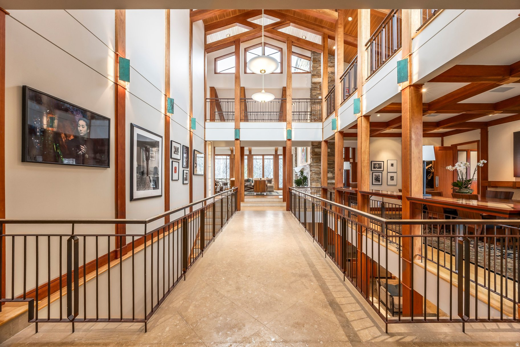A one-of-a-kind architectural masterpiece inspired by the timeless vision of Frank Lloyd Wright, designed by noted Utah architect Max Smith and built by Craig Construction. Rooted in nature and elevated by design, this living gallery in the trees is a rare expression of art and architecture in harmony. Nestled on a premier corner lot among a canopy of aspens, this 10,157-square-foot estate offers exceptional privacy while making a striking artistic statement. Every line, material, and sightline reflects the philosophy that a home should exist in balance with its surroundings. With 5 bedrooms and 8 baths, the residence blends warmth and grandeur through horizontal lines, walls of glass, natural stone, and rich wood detailing. Sunlight fills thoughtfully curated interiors, where custom built-ins and museum-quality finishes transform each space into livable art. Designed for both intimate gatherings and grand entertaining, the home flows seamlessly from dramatic indoor spaces to expansive outdoor terraces. A stunning great room anchors the residence, complemented by formal and informal dining areas, a chef's kitchen with professional-grade appliances, and inviting lounge spaces. The primary suite offers a private retreat with serene aspen views, a spa-inspired bath, and boutique-style dressing rooms. Guest suites provide comfort and seclusion, each carefully positioned to preserve the home's sense of tranquility. More than a residence, this estate is a statement-where architecture becomes art and living becomes an experience.