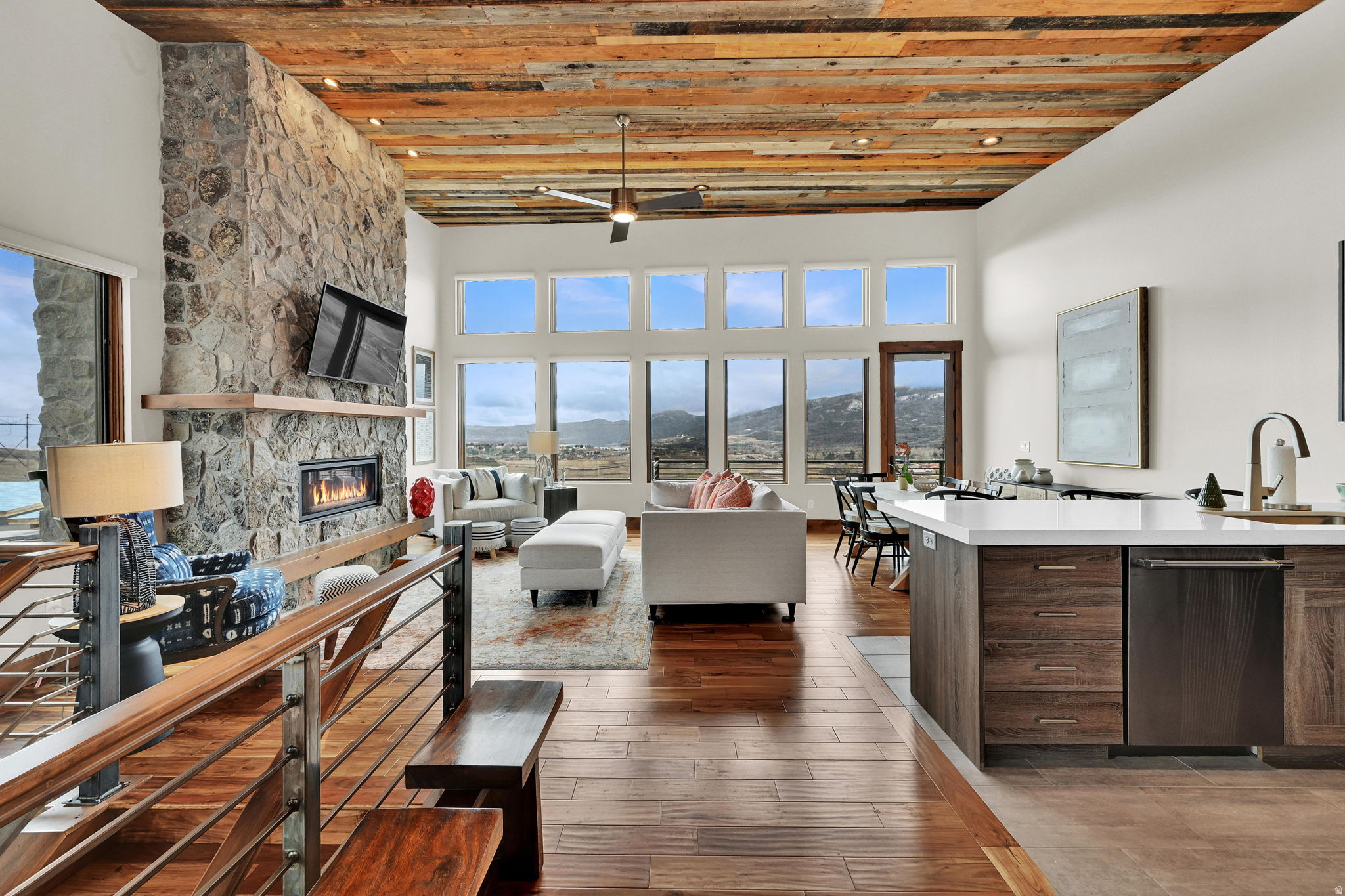The luxury mountain-modern townhome you've been waiting for - this fully furnished end-unit townhome has never been used as a rental, and is in truly pristine condition! Professionally furnished with high-end, bespoke pieces throughout - from custom window shades and drapes, impeccable hardwood floors, designer curated bedrooms, and an over-sized outdoor jacuzzi - no detail has been overlooked. As you enter through the front door you'll find a tastefully furnished living room, custom barn wood ceiling, and spacious kitchen featuring lightly used Thermador professional-grade appliances. A floor to ceiling rock fireplace with mantle is perfect for enjoying winter nights in comfort. A private deck, accessible from living room and primary bedroom, offers breathtaking, unobstructed views of the surrounding mountains, lake, and valley floor. The primary suite offers ample space to relax, and bathroom features heated floors, custom barn door slider, oversized glass/tile shower, and a deep soaking tub that has never been used. A mud room off the 2-car garage features a washer/dryer and a custom bench and coat rack for storing winter clothing. On the lower level you will find an additional living area with custom dry-bar, an additional floor to ceiling rock fireplace, 3 more bedrooms and bathrooms, 2 of which are en-suite bathrooms, and a large theatre/game room. These lower level bedrooms have seen very light use, some beds have never been slept in! Step onto the oversized walkout cement patio and enjoy sweeping mountain and valley views while you relax in your high-end Bullfrog jacuzzi. This Ridge townhome is located just steps from the HOA plunge pool and jacuzzi, a shuttle stop to Powder Mountain, and just a few minutes drive to Wolf Creek Golf Course, Nordic Valley, Snow Basin ski resort, Pineview Reservoir, and miles of hiking and biking trails.