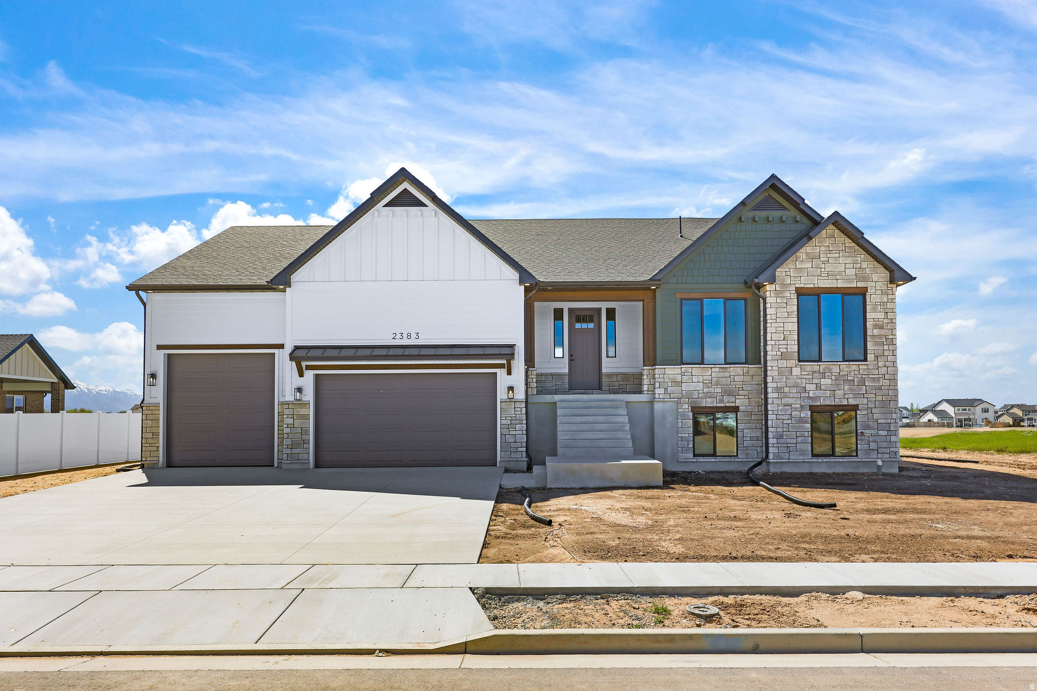 This Beautiful Custom Raised Rambler Is Complete & Ready To GO!! The welcoming covered porch leads into an open great room with vaulted ceilings, a fireplace and oversized windows. The custom kitchen is loaded with premium upgraded cabinetry, Quartz countertops, gas cooktop, double ovens, walk-in pantry, and sunroom-style dining. Main-floor master suite has extra soundproofing insulation, and features private separate access to the large covered Trex deck. Mudroom, laundry room, and oversized 4-car garage for all your toys. 2 additional Bedrooms, Full Bath and Laundry already finished in the basement with separate entrance and rough-ins for full kitchen, family room and  more bedrooms-ideal for an in-law suite or rental. Call today to schedule your showing!