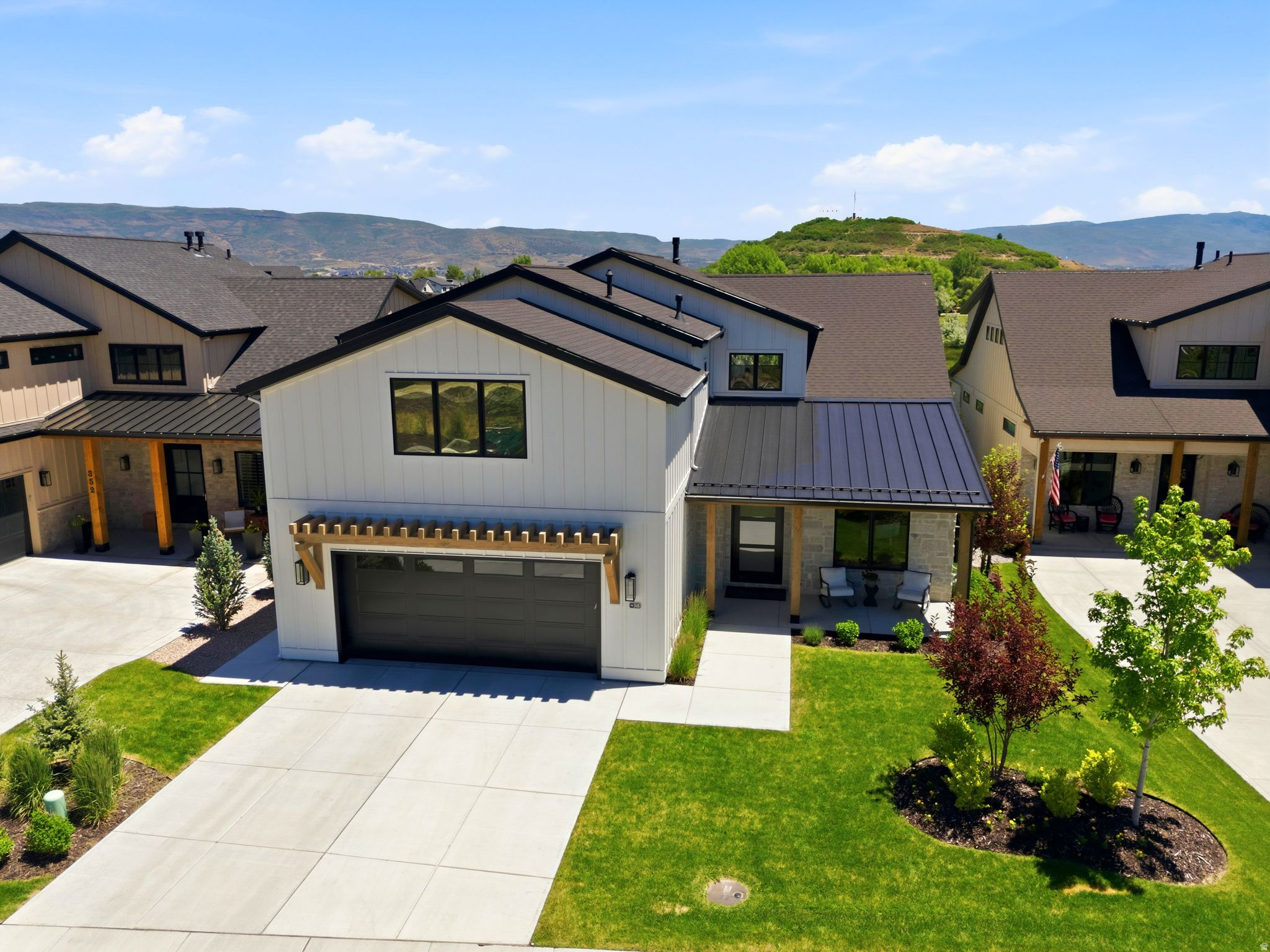 Thoughtfully upgraded and impeccably maintained, this exceptional residence offers protected open space views with a finish level of quality and customization that is rare to find. From the moment you enter, you'll appreciate the stunning stone entryway and floor-to-ceiling stone fireplace that creates a warm yet sophisticated first impression. The open-concept floor plan is filled with natural light and designed for effortless entertaining. At the heart of the home is a daylight chef's kitchen featuring a 48" range, double ovens, quartz countertops, large eat-in island, beverage center, and a spacious walk-in pantry. The dining and family rooms flow seamlessly together, creating inviting spaces for both everyday living and hosting guests. The luxurious main-level owner's suite offers a spa-inspired ensuite bath with dual vanities, a large walk-in shower, enclosed commode, and generous walk-in closet. Continue to the mud/laundry complete with side-by-side washer and dryer, utility sink, and custom lockers. A thoughtfully designed office with built-in cabinetry and accent wall complete the main level. Upstairs, soaring 9-foot ceilings create a sense of openness for the secondary family room that serves as the perfect theater. Complemented by a stylish wet bar kitchenette, making it ideal for entertaining. 4 spacious spacious guest rooms and 3 full bathrooms round out the second level. Designed with comfort and convenience in mind, additional features include automated lighting, ceiling fans, whole-house water filtration system, whole-house fan, and motorized shades throughout all bedrooms and patio areas. The oversized garage features professionally coated flooring and 240V infrastructure for electric vehicle charging. Outside, enjoy the custom stone fire pit and take in the views of Memorial Hill and miles of protected open space. Ideally located just minutes from world-renowned ski resorts, golf courses, reservoirs, outdoor trails, and historic Midway Main Street.