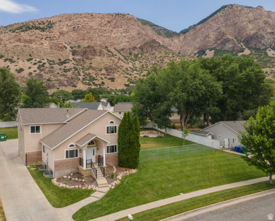 Rare opportunity to own an incredibly spacious 7-bedroom, 4-bath home with room for everyone, all situated on a combined .53 acres with the adjacent lot included (Tax ID 112490012). One of the standout features of this property is the massive garage and parking setup, offering space for up to 5 vehicles inside plus an oversized driveway with abundant off-street parking for RVs, trailers, toys, guests, and more. The additional lot creates a large yard with endless possibilities for recreation, gardening, future improvements, or simply enjoying the extra space and privacy. Inside, the home has seen numerous updates, including HVAC, kitchen, countertops, and bathrooms, along with brand-new garage doors, windows and a new front door. This property was previously used as a business, and could be continued to be used for a day care, micro-school, shop for trade business, etc.  Square footage figures are provided as a courtesy estimate only and were obtained from Weber County records. Buyer is advised to obtain an independent measurement.