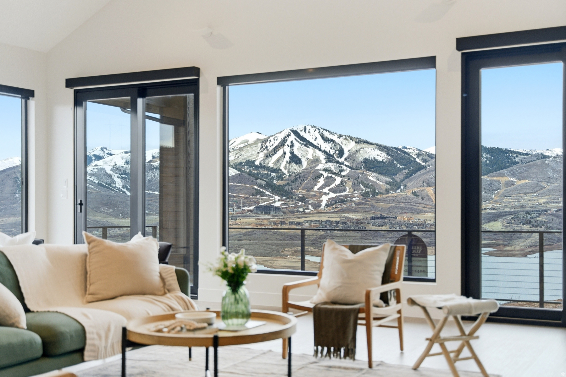 Spectacular Deer Valley, Jordanelle Reservoir, and Mount Timpanogos views define this exceptional new mountain modern residence. Perched on a premier cul-de-sac homesite above the Jordanelle, this thoughtfully designed home captures sweeping panoramas with coveted southwestern exposure, offering stunning sunsets and abundant natural light throughout the day. Designed by an award-winning Boston-based architect, the residence seamlessly blends contemporary mountain elegance with functional living spaces. Featuring five bedrooms and five bathrooms, the home is ideally suited for both entertaining and comfortable family living. The expansive front deck, complete with a private hot tub, showcases breathtaking views of the ski slopes, Jordanelle Reservoir, and surrounding peaks, creating an unforgettable setting for aprs-ski relaxation. A generous rear deck provides a more intimate outdoor retreat, perfect for morning coffee, quiet reading, or al fresco dining in the comfort of afternoon shade. Inside, open-concept living spaces are complemented by a secondary family room, offering additional flexibility for movie nights, board games, and gathering with friends and family. Ideally located just minutes from Deer Valley East Village, Kimball Junction, and Historic Park City, this home offers convenient access to world-class skiing, dining, shopping, and year-round recreation.