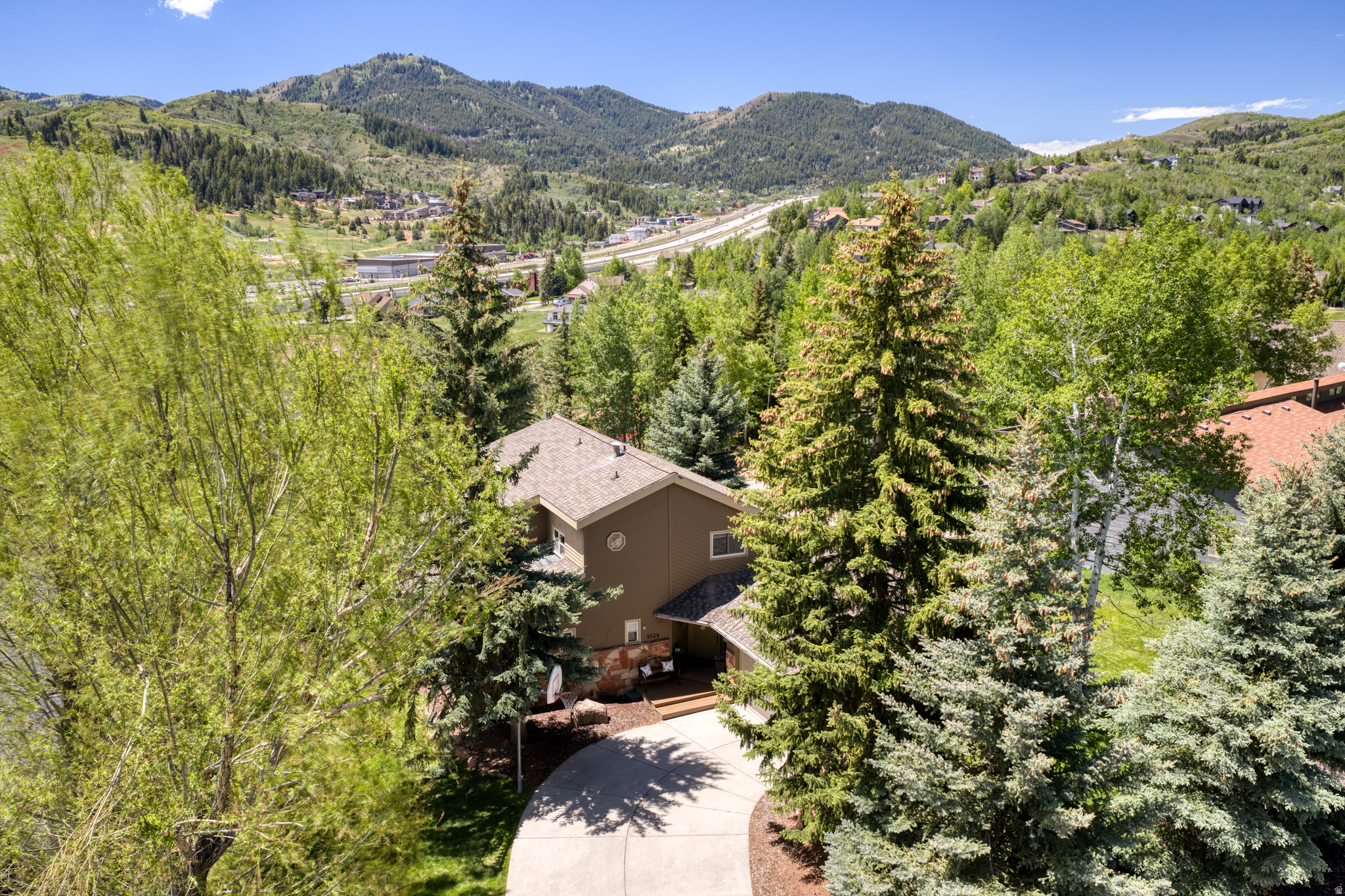 Welcome to this exceptional family home nestled in one of Park City's most coveted neighborhoods - Jeremy Ranch. Bathed in natural light and framed by mature trees, this 4,700 sq ft home offers the perfect blend of mountain living and modern comfort. Enjoy sweeping views of the surrounding peaks and the iconic Woodward Park City from the newer Trex deck, an ideal gathering space for entertaining, outdoor dining, or simply relaxing. At the heart of the home is a beautifully remodeled chef's kitchen, where a generous island invites everyone to gather and has an inviting flow into the dining and main living area making this home ideal for entertaining as it is for everyday family life. The upper level primary suite features a recently reimagined spa-inspired bathroom and peaceful separation from the rest of the home. A second bedroom upstairs offers versatility as a home office or guest room. Two additional bedrooms and 1 bathroom plus powder room on the main level provide ample room for family, while the fully appointed lower level - complete with two bedrooms, 1 bathroom, a kitchenette, laundry, and a separate entrance - has been successfully used as a seasonal rental, offering meaningful income potential or the perfect space for multigenerational living. Outside, mature trees and a firepit area create a welcoming setting .The oversized driveway accommodates up to 4 additional vehicles in addition to the 2-car garage. All just 30 minutes from Salt Lake City International Airport, 15 minutes to Main St. Park City, and moments from world-class skiing, mountain biking, and hiking trails. This is the one you've been waiting for ...thoughtfully improved ,spacious, beautiful views and flexibility which is increasingly hard to find!