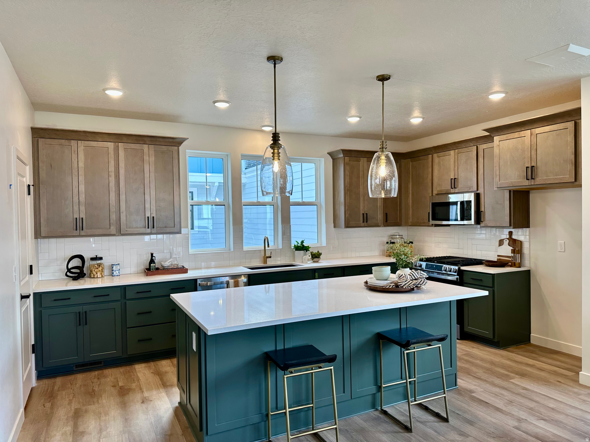 Walk to Soda Row New townhomes in one of Daybreak's most established neighborhoods, just a 10-minute walk to Soda Row, the new minor league ballpark, the library, and TRAX. Ask about DWHomes and PHM personalizing your Home Loan! Experience modern luxury in the stunning upscale home near Downtown Daybreak (only 10 minutes away), designed for seamless living and entertaining. Imagine hosting gatherings in your game room with an outdoor terrace- a perfect spot to relax or connect with friends and family. With private guest suites on both the first and third floors, everyone has their own comfortable retreat. Call for an appointment today!