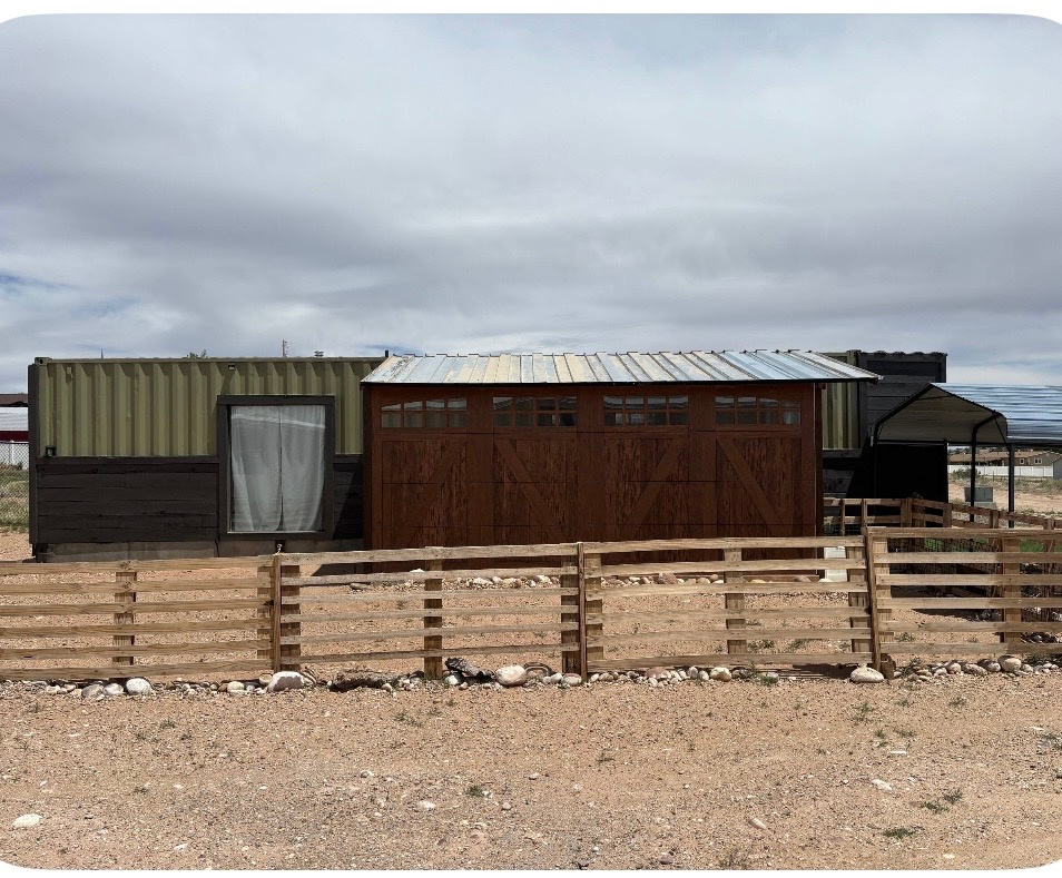 This cute container home would be perfect for weekend fishing getaways or recreation. 2 bedrooms, 1 bath. All hooked up to city water, sewer, and power! Graveled drive. Covered patio. Splits provide heating and A/C! You can camp here or live here year round! 0.184 acre. Tiny Home on a tiny but comfortable fenced lot. . This is a very quiet area with beautiful views of the mountains and about 5 minutes from Starvation Reservoir.