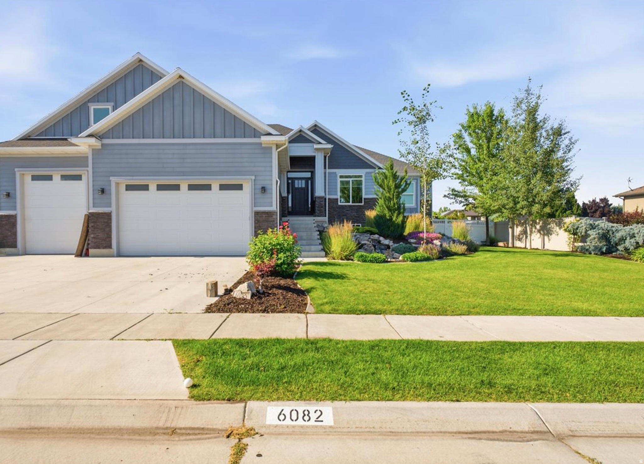 Welcome to this exceptional, custom-built luxury estate in the highly sought-after community of Hooper, Utah. Perfectly situated on a pristine, beautifully landscaped .45-acre lot, this magnificent residence offers a rare blend of refined elegance, high-end custom finishes, and unmatched functionality. From the moment you arrive, the incredible curb appeal sets the stage with a tranquil front yard waterfall feature and meticulously maintained landscaping.  Step inside to experience true craftsmanship, anchored by stunning, rich walnut flooring that flows seamlessly throughout the main level. The inviting living room serves as the ultimate gathering space, centered around a beautiful warm fireplace perfect for crisp Utah evenings. Just off the living area, the show-stopping gourmet kitchen features premium granite countertops, high-end finishes, and an expansive walk-in pantry designed for effortless organization. Whether you are hosting a grand holiday party or enjoying a quiet night in, the ambiance is always dialed in thanks to a whole-house built-in Sonos speaker system. The main-floor primary suite serves as your private sanctuary, boasting an expansive walk-in closet, his-and-her sinks, a beautiful full shower, and a luxurious soaking tub complete with a dedicated TV-creating a true spa-like escape.  The 90% finished basement offers incredible flexibility and massive space, featuring: Two full bedrooms and a pristine full bathroom. Mother-in-Law Potential: The space is already fully plumbed and ready for kitchen/cabinet installation, making it incredibly easy to convert into a fully independent living suite or an epic secondary entertaining zone.  Step out back to discover your private backyard retreat, featuring an incredible multi-level outdoor living space. Enjoy the view from the covered deck, or step down to the patio complete with its own cozy outdoor fireplace. All of this overlooks a fully fenced yard.   For car enthusiasts, hobbyists, or those craving premium space, this property is in a league of its own: The Main Garage: An attached, heated 4-car garage ensures your daily drivers and weekend toys are kept in pristine condition year-round. The Detached Shop: A massive 30' x 40' detached shop equipped with its own dedicated heating system, extra-tall bay doors perfect for your RV or boat, and a convenient smaller rear garage door for pull-through access. The Loft / Future Hangout: Perched above the shop is a huge loft space ready to be the ultimate future hangout spot, man cave, or game room. Bring your finishing touches to customize this incredible bonus space exactly how you want it!  This is more than just a house-it is a lifestyle. Offering the perfect balance of rural tranquility and upscale, custom luxury, this Hooper estate presents a rare opportunity to own something truly extraordinary. Schedule your private tour today!      Square footage figures are provided as a courtesy estimate only and were obtained from county records .  Buyer is advised to obtain an independent measurement.