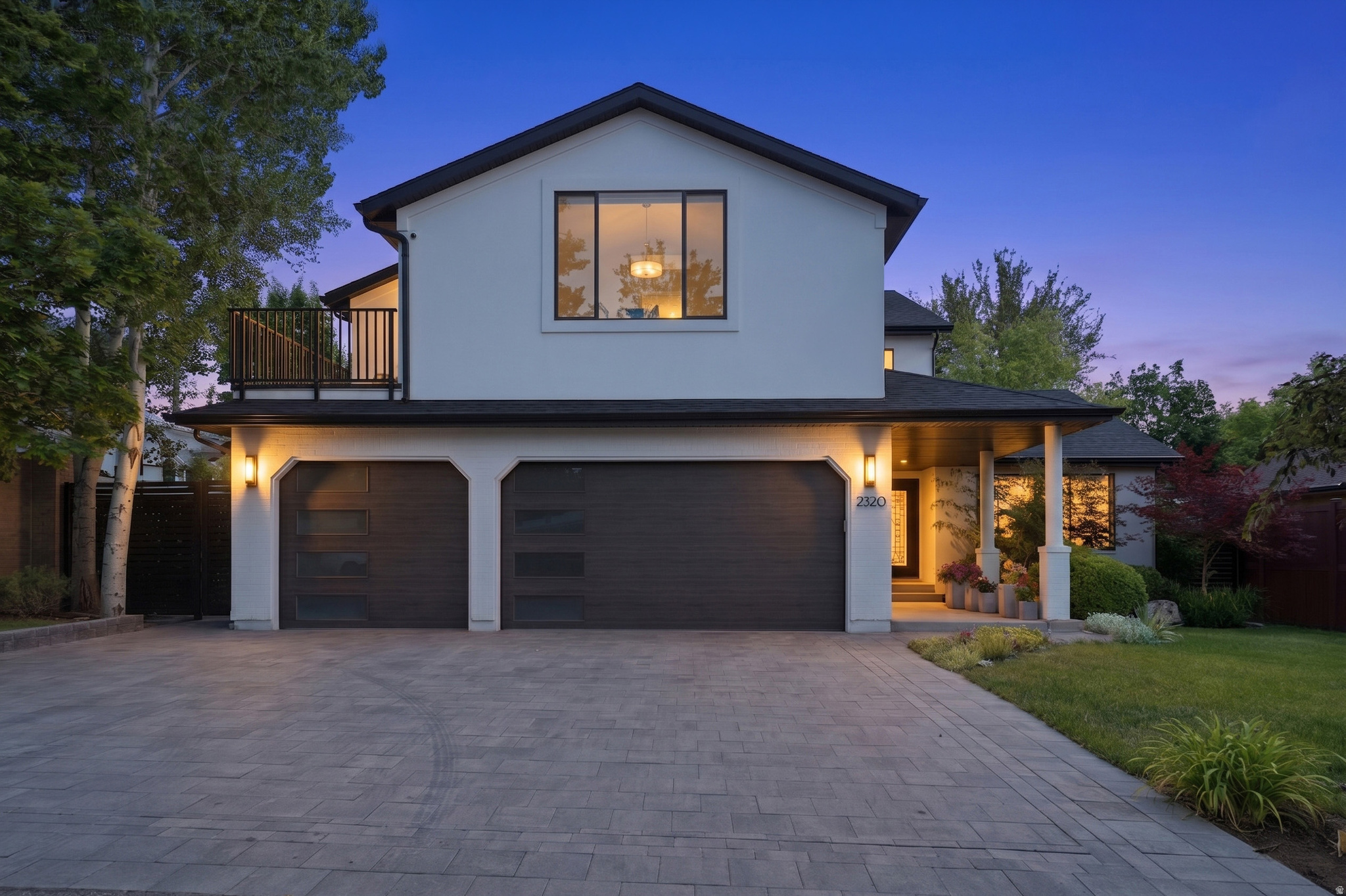 A Holladay Haven - Nearly 5,000 square feet of custom modern elegance in one of Salt Lake City's most desirable, walkable neighborhoods. This exceptional residence offers five en suite bedrooms, seven bathrooms, and beautifully designed indoor-outdoor living spaces. The luxurious primary suite features a private balcony, an all-marble bath with separate soaking tub and shower, and an expertly designed walk-in closet. The custom walnut kitchen showcases quartzite countertops, Sub-Zero and Wolf appliances, a built-in dining area, and an adjoining lounge that opens to a spacious paver patio and private, professionally landscaped backyard. Elegant living and dining rooms extend to a shaded patio, creating an ideal setting for alfresco dining and entertaining. A main-floor office captures mountain views. Upstairs includes three en suite bedrooms, two private balconies, and a full laundry room. The fully finished walkout lower level offers outstanding flexibility with a separate entrance, two en suite bedrooms, a second kitchen with stainless-steel appliances and dining island, laundry, family room, and dining or bonus space-ideal for guests, extended family, or private living quarters. Additional features include a detached outdoor studio overlooking the hot tub, patio, built-in fire-pit, and landscaped grounds - all in a fully fenced backyard. Exquisite hand laid paver driveway and patios elevate the outdoor living areas. You'll appreciate the three-car garage with EV charging,  extensive built-in storage and newer garage doors. Two central air units, two furnaces, and three ductless mini-split systems provide individualized comfort throughout. A rare, one-of-a-kind home offering privacy, sophistication, and a warm, serene atmosphere near shopping, dining, entertainment, and community gathering spaces.