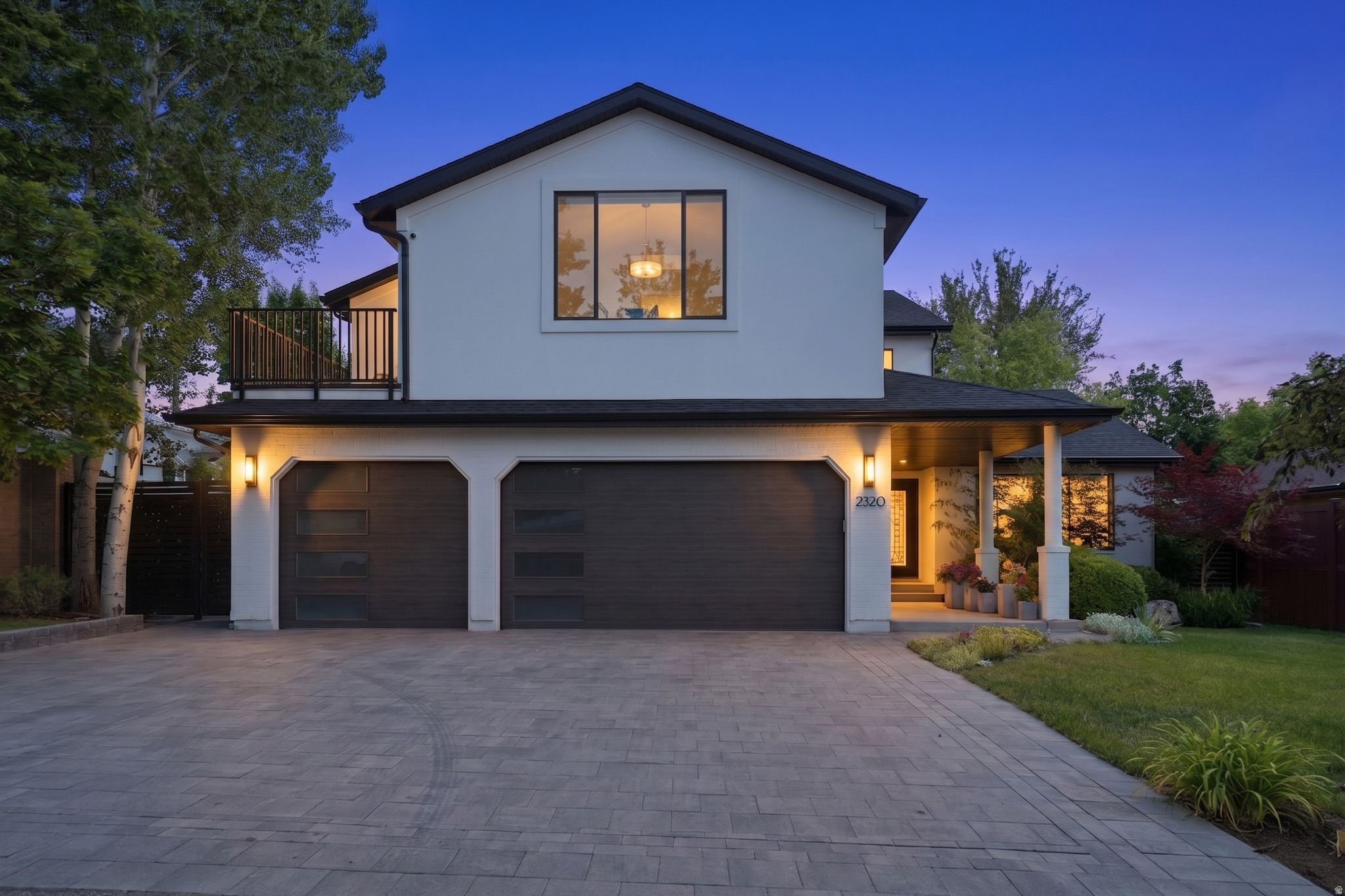 A Holladay Haven - Nearly 5,000 square feet of custom modern elegance in one of Salt Lake City's most desirable, walkable neighborhoods. This exceptional residence offers five en suite bedrooms, seven bathrooms, and beautifully designed indoor-outdoor living spaces. The luxurious primary suite features a private balcony, an all-marble bath with separate soaking tub and shower, and an expertly designed walk-in closet. The custom walnut kitchen showcases quartzite countertops, Sub-Zero and Wolf appliances, a built-in dining area, and an adjoining lounge that opens to a spacious paver patio and private, professionally landscaped backyard. Elegant living and dining rooms extend to a shaded patio, creating an ideal setting for alfresco dining and entertaining. A main-floor office captures mountain views. Upstairs includes three en suite bedrooms, two private balconies, and a full laundry room. The fully finished walkout lower level offers outstanding flexibility with a separate entrance, two en suite bedrooms, a second kitchen with stainless-steel appliances and dining island, laundry, family room, and dining or bonus space-ideal for guests, extended family, or private living quarters. Additional features include a detached outdoor studio overlooking the hot tub, patio, built-in fire-pit, and landscaped grounds - all in a fully fenced backyard. Exquisite hand laid paver driveway and patios elevate the outdoor living areas. You'll appreciate the three-car garage with EV charging,  extensive built-in storage and newer garage doors. Two central air units, two furnaces, and three ductless mini-split systems provide individualized comfort throughout. A rare, one-of-a-kind home offering privacy, sophistication, and a warm, serene atmosphere near shopping, dining, entertainment, and community gathering spaces.