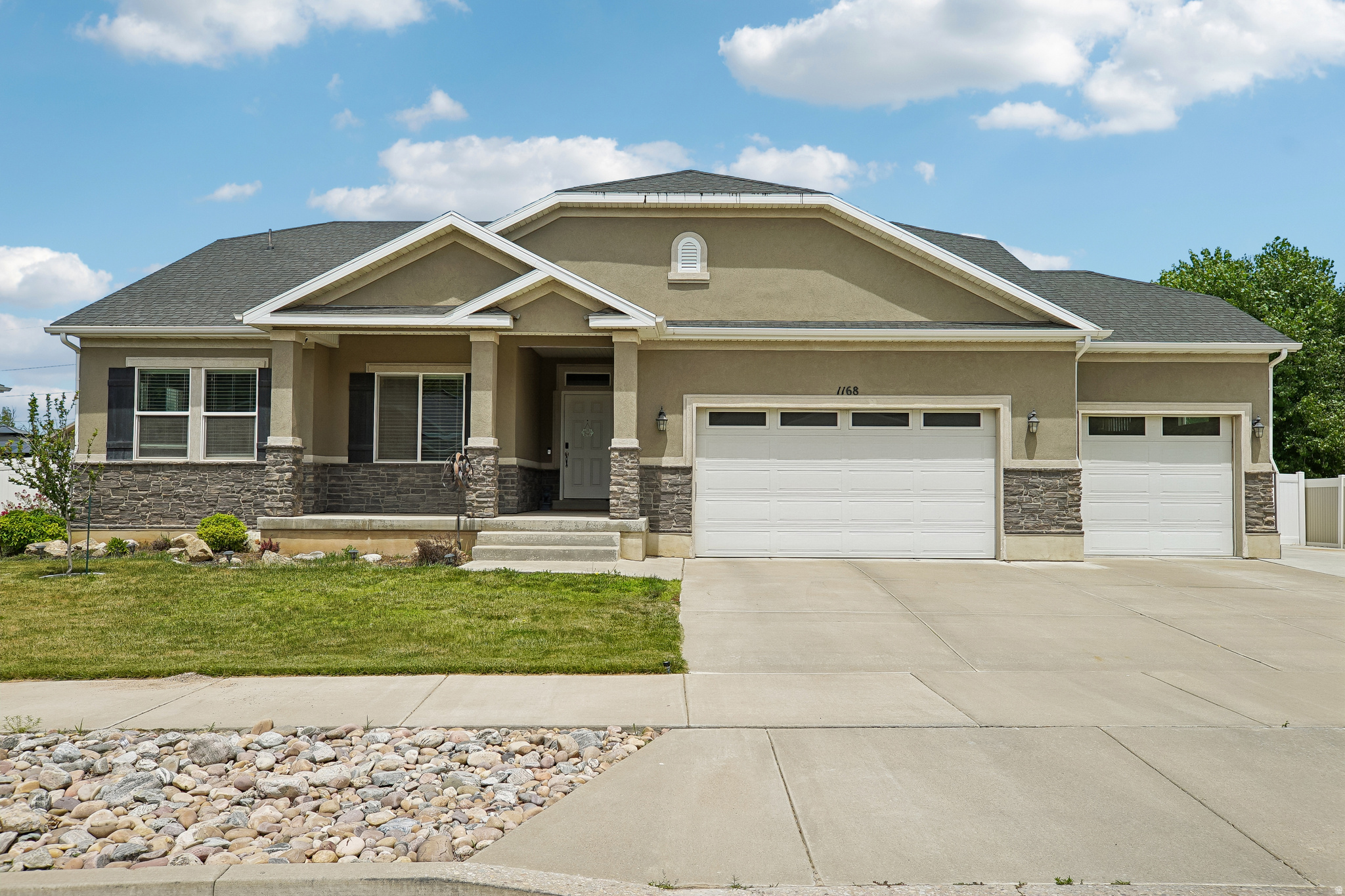 Nestled on a generous quarter-acre lot in the heart of South Weber, this beautiful, fully finished rambler boasts over 3,500 square feet of versatile living space, complete with a massive backyard deck framing gorgeous mountain views and plenty of green space for family and pets. The main level welcomes you with an airy, open-concept great room with soaring vaulted ceilings that flow into a spacious kitchen equipped with granite countertops, a gas range, and a walk-in pantry. Designed with a smart split-bedroom layout for maximum privacy, the main floor hosts a luxurious primary suite with a walk-in closet and separate tub and shower on one side, two additional bedrooms and a full bath on the other, and a convenient main-level laundry room. Downstairs, the expansive, fully finished basement features abundant dry storage and doubles perfectly as a mother-in-law suite, offering a kitchenette, separate living area, an additional bedroom, office space, and a modern bathroom. Complete with an oversized 3-car garage and a wide driveway equipped for RV parking, this exceptional home truly checks every box.