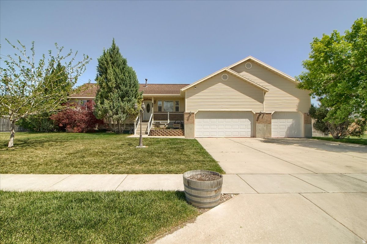 Welcome home to this well-maintained Magna rambler offering space, function, and thoughtful updates throughout. The bright and open floor plan creates an inviting feel with comfortable living spaces and great natural light. The spacious primary suite features a cedar-lined closet and an en suite bathroom with separate tub and shower. Major value-added improvements include a newer furnace and A/C with humidifier, newer roof, and a whole house attic fan for added comfort and efficiency. Situated on a fully fenced 0.33-acre lot, the property includes a gated 14x30 RV pad, covered carport, and oversized 3-car garage with plenty of room for parking, storage, and hobbies. The finished basement offers a large family room, three additional bedrooms, and a plumbed space ready for a future bathroom. Clean, cared for, and move-in ready.