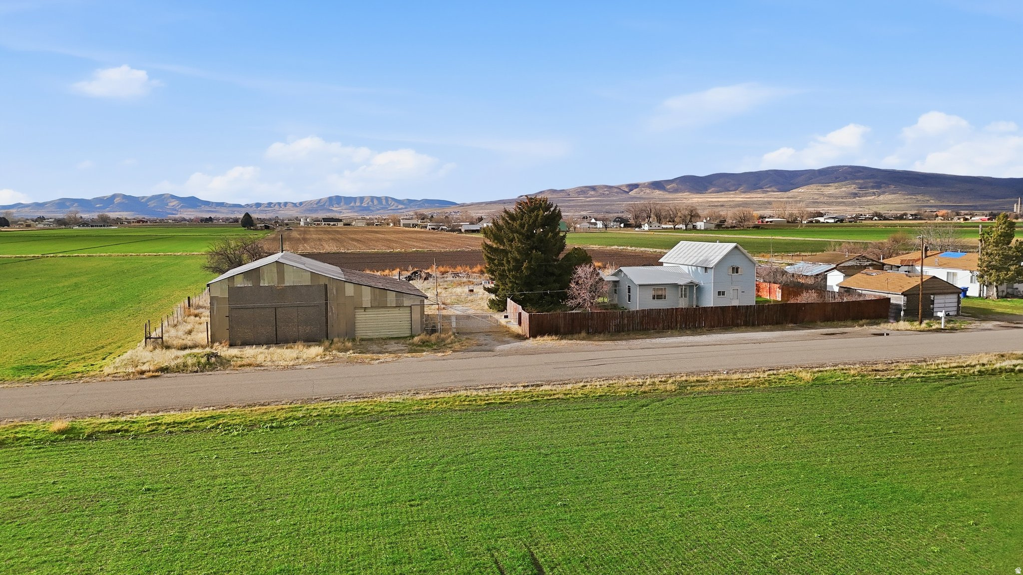 Looking for a shop property? This 0.50-acre parcel on the outskirts of Tremonton features an approximately 2,500 sq ft shop, making it a great opportunity utilize the existing shop for your personal, business or ag needs. The property includes an electric gate for added security and convenience, and the shop is connected to power. The shop is being sold as-is. Also included is  share of Bear River Canal irrigation water, adding value and utility to the property. Great opportunity for anyone looking for shop space, land, and flexibility in a convenient Tremonton location. Buyer to verify all information.